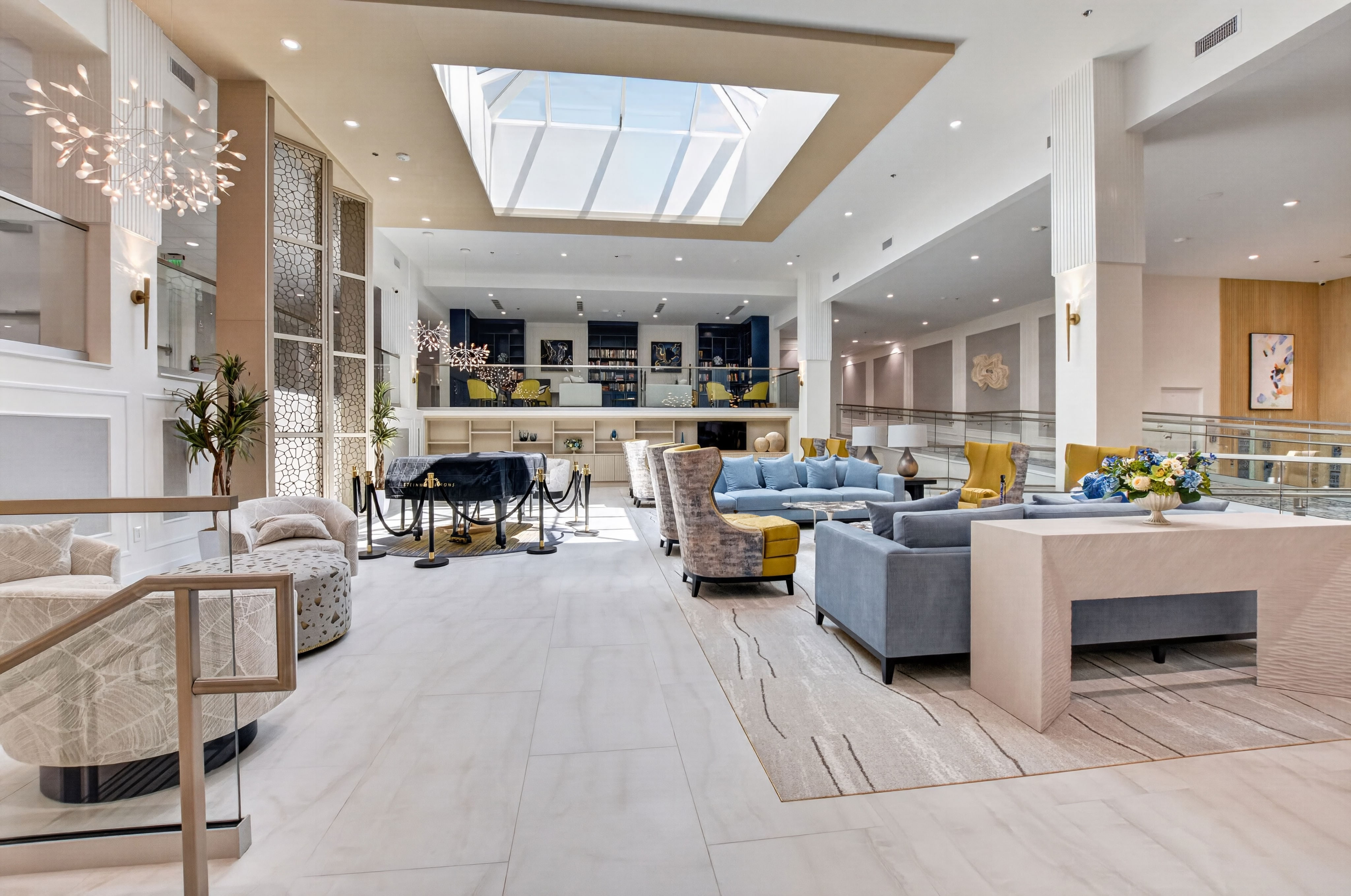 Bright Palm Isles clubhouse lounge with contemporary seating, a skylight, and gathering spaces