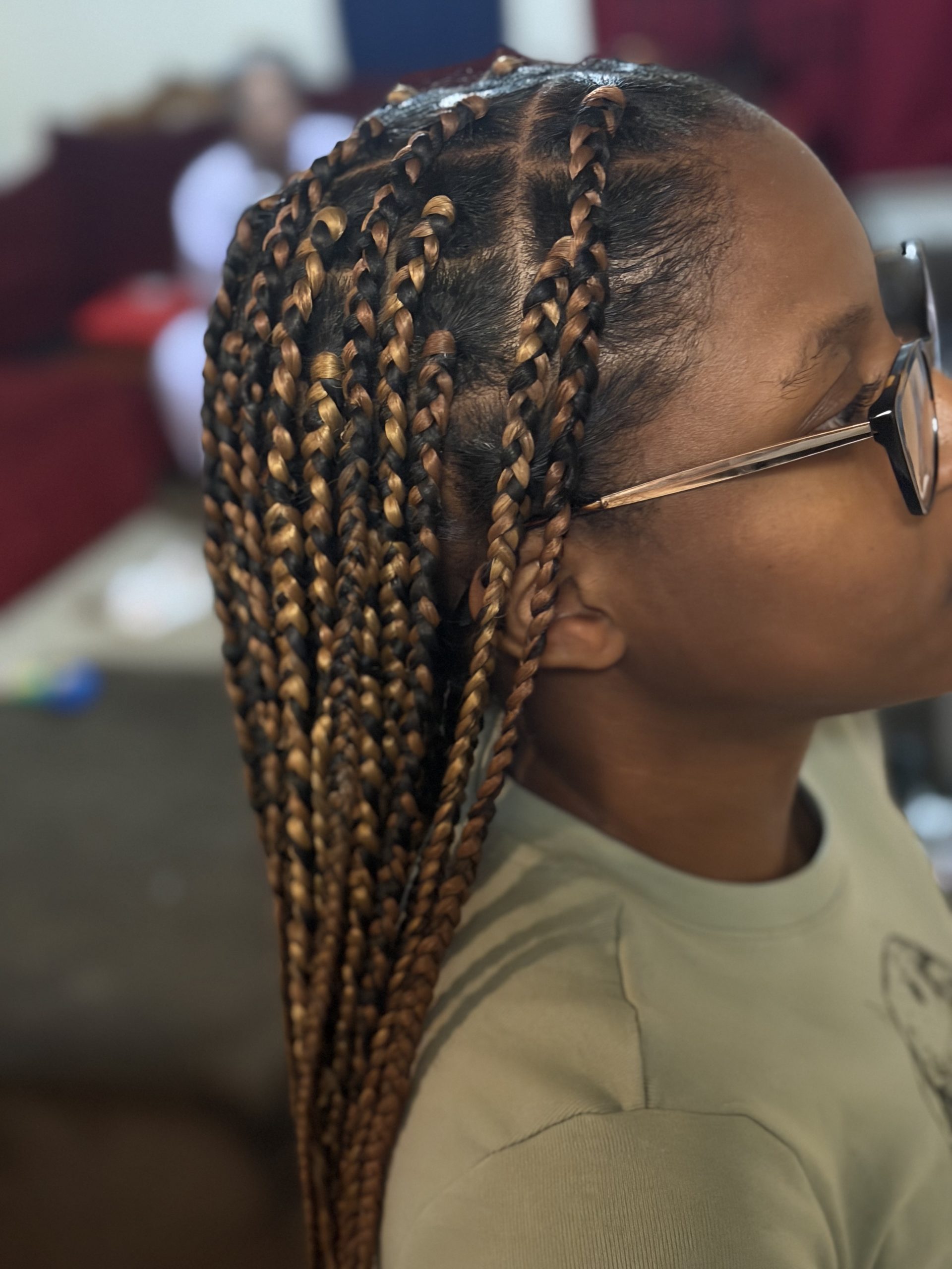 Side view of long knotless braids with gold accents