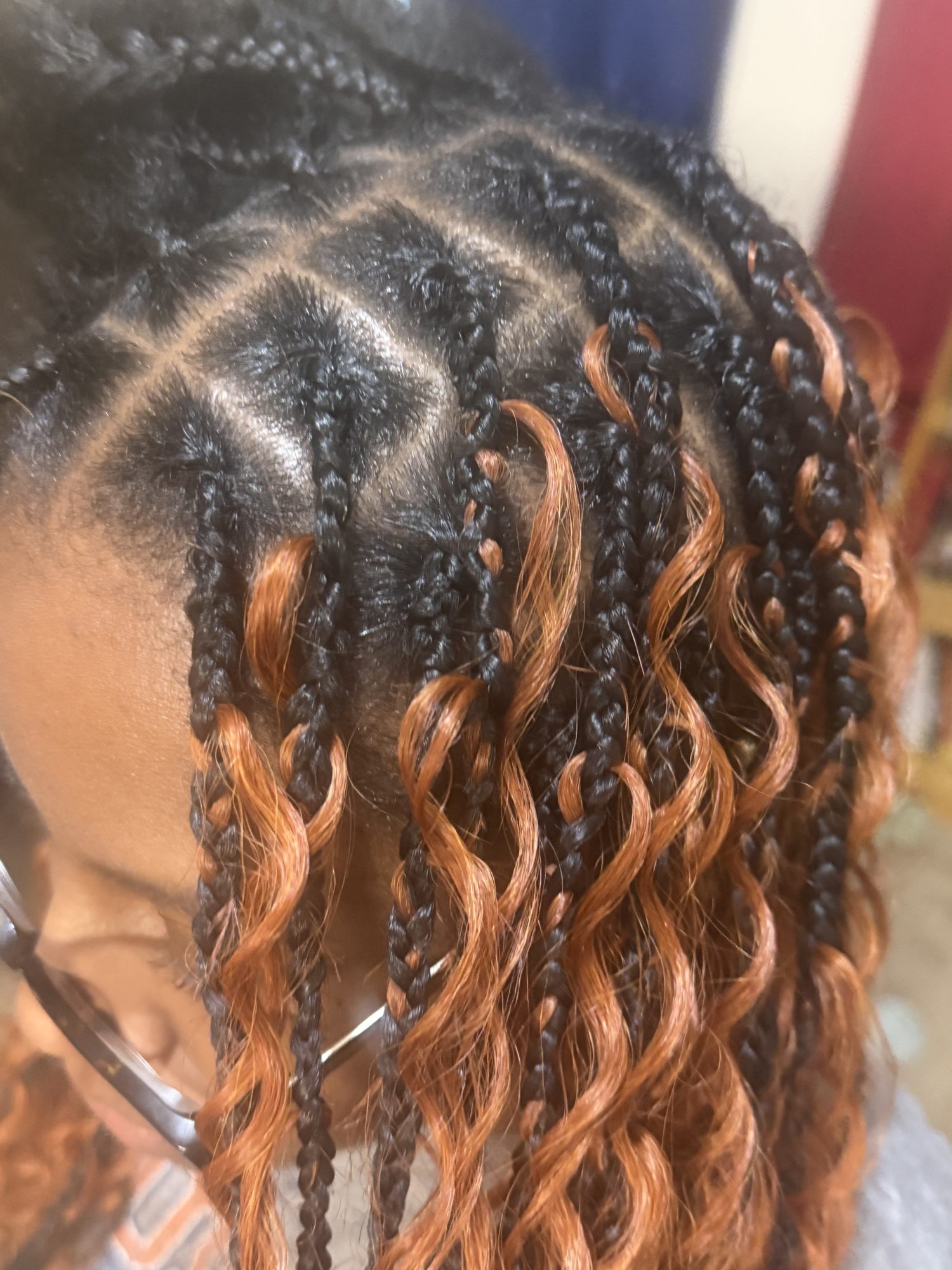 Detailed braided style with warm copper curls