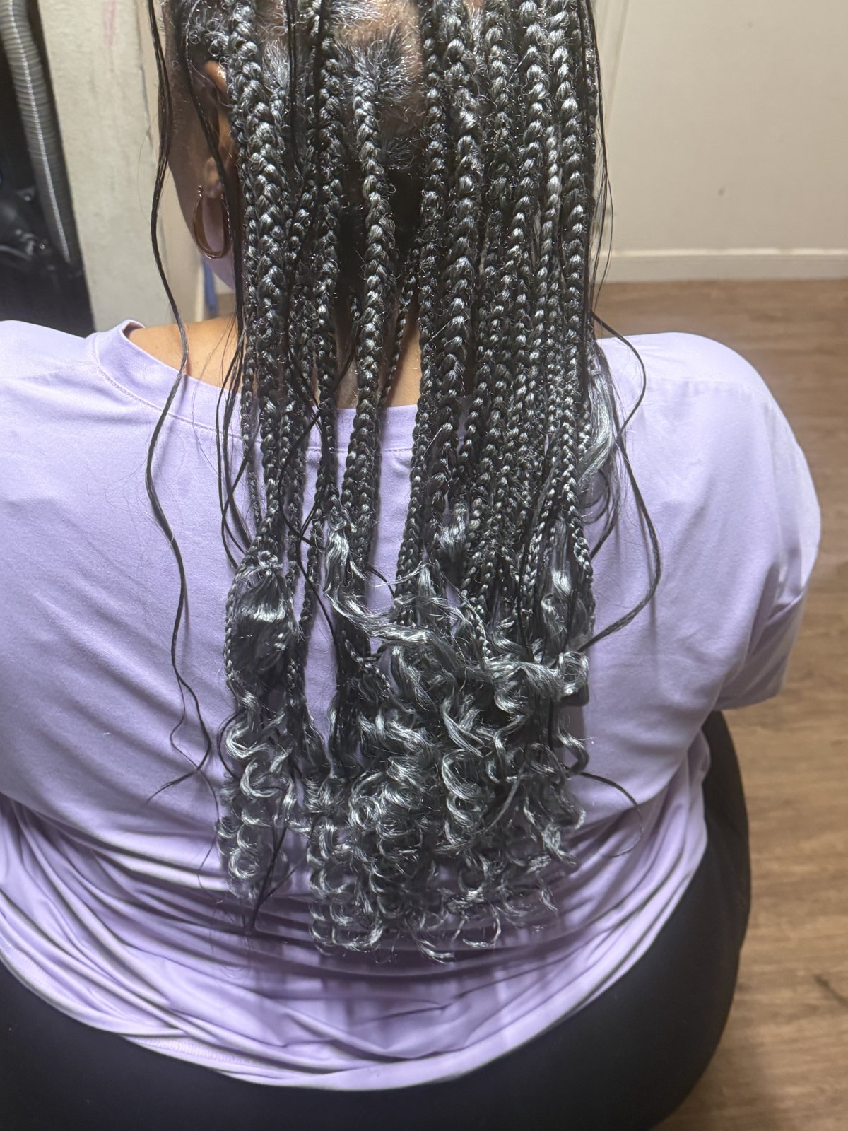 Back view of long braids with loose curls