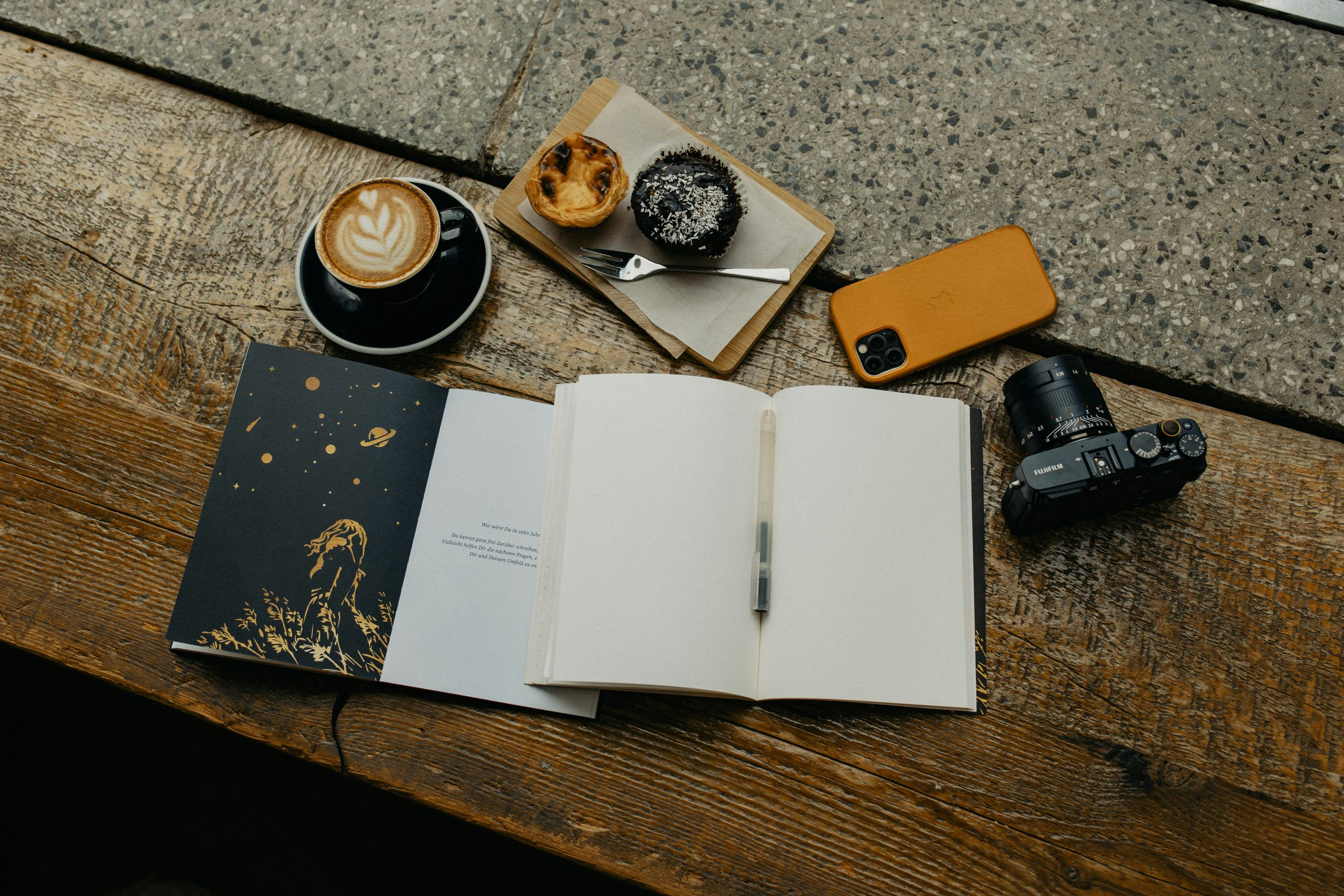 Open book and coffee cup on a wooden table for a thoughtful gift idea