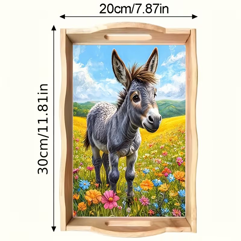 Sweet gray donkey standing in a colorful wildflower meadow on a decorative tray