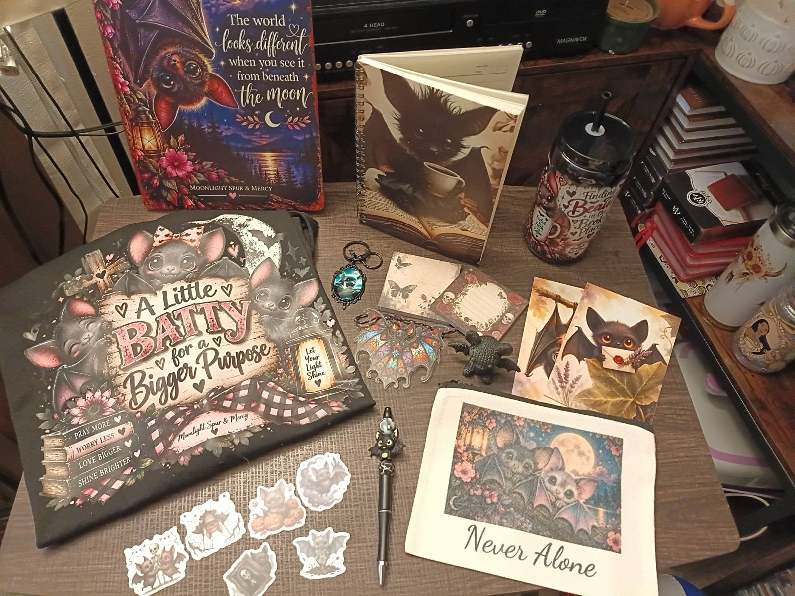Actual Batty Bundle treasures including a shirt, bat decorations, notebook, stationery, and cup