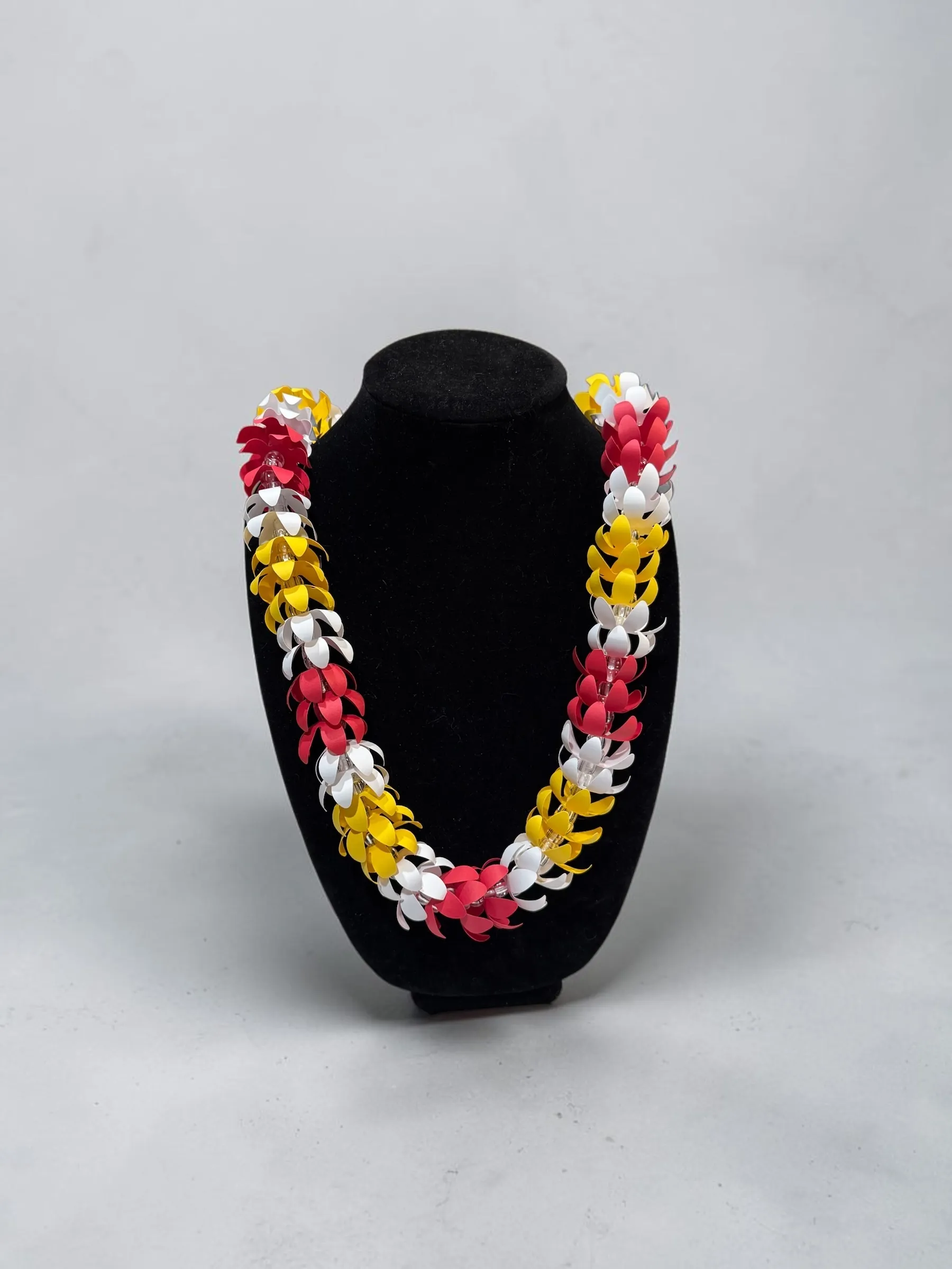 Handmade paper lei in red, white, and yellow