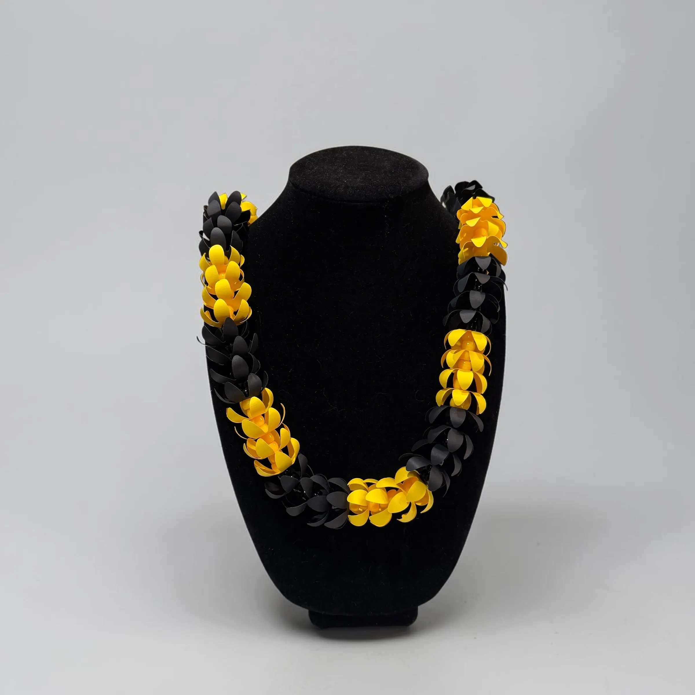 Handmade paper lei in black and yellow