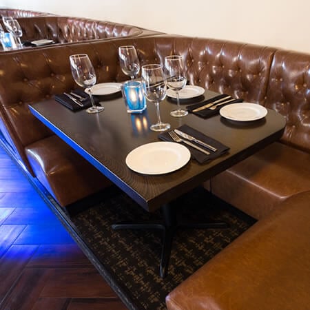 Commercial table bases and tabletops in a furniture showroom setting