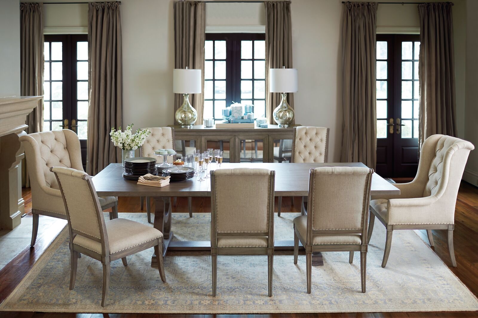 Refined dining room with an upholstered dining table and tall back chairs