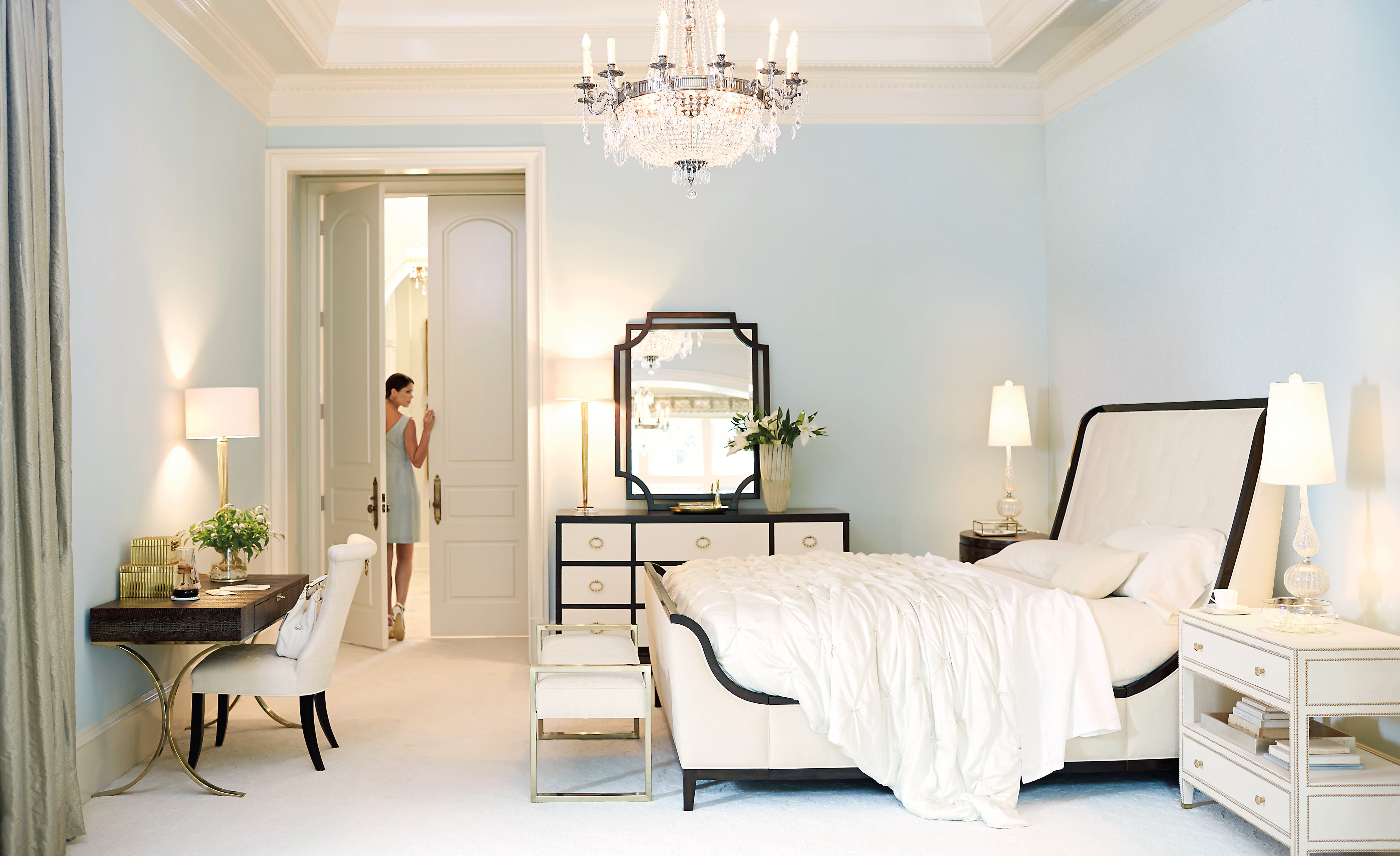 Light blue luxury hotel guest room with chandelier and upholstered furnishings