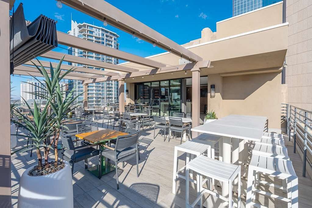 Outdoor hospitality dining setting with tables and woven chairs