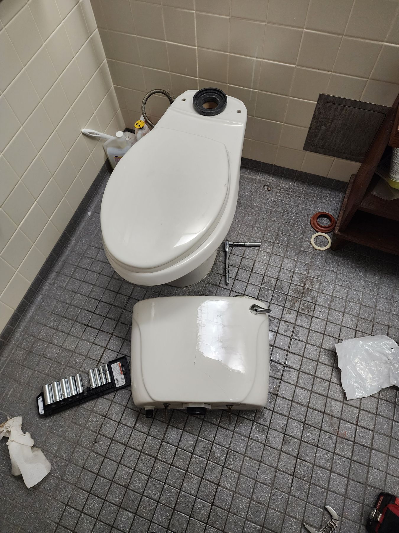 Toilet repair in progress during a home maintenance visit