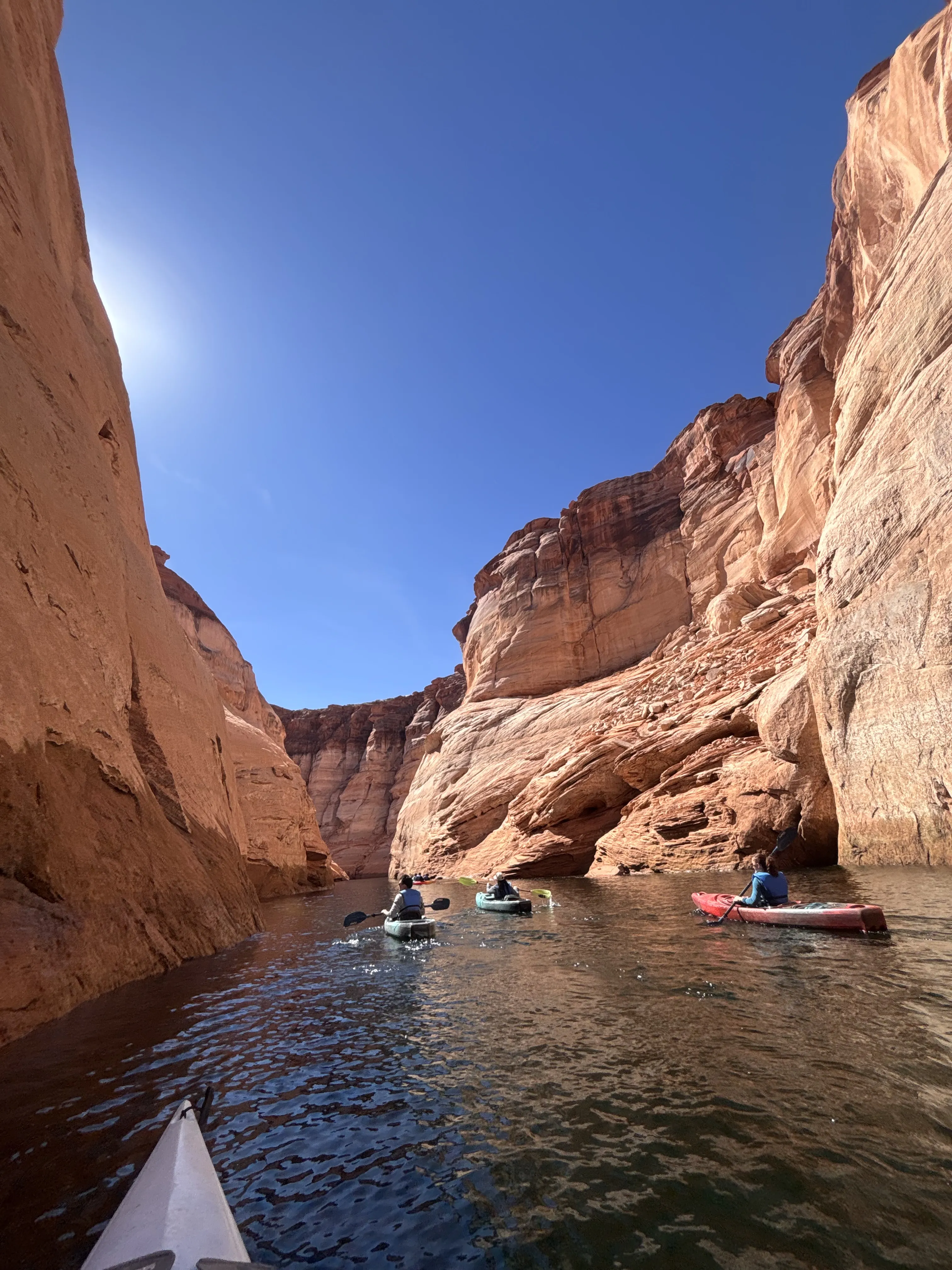 Still water reflecting a sandstone canyon