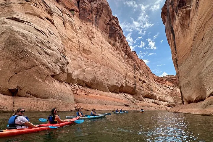 A small group of kayakers gathering on calm Lake Powell water