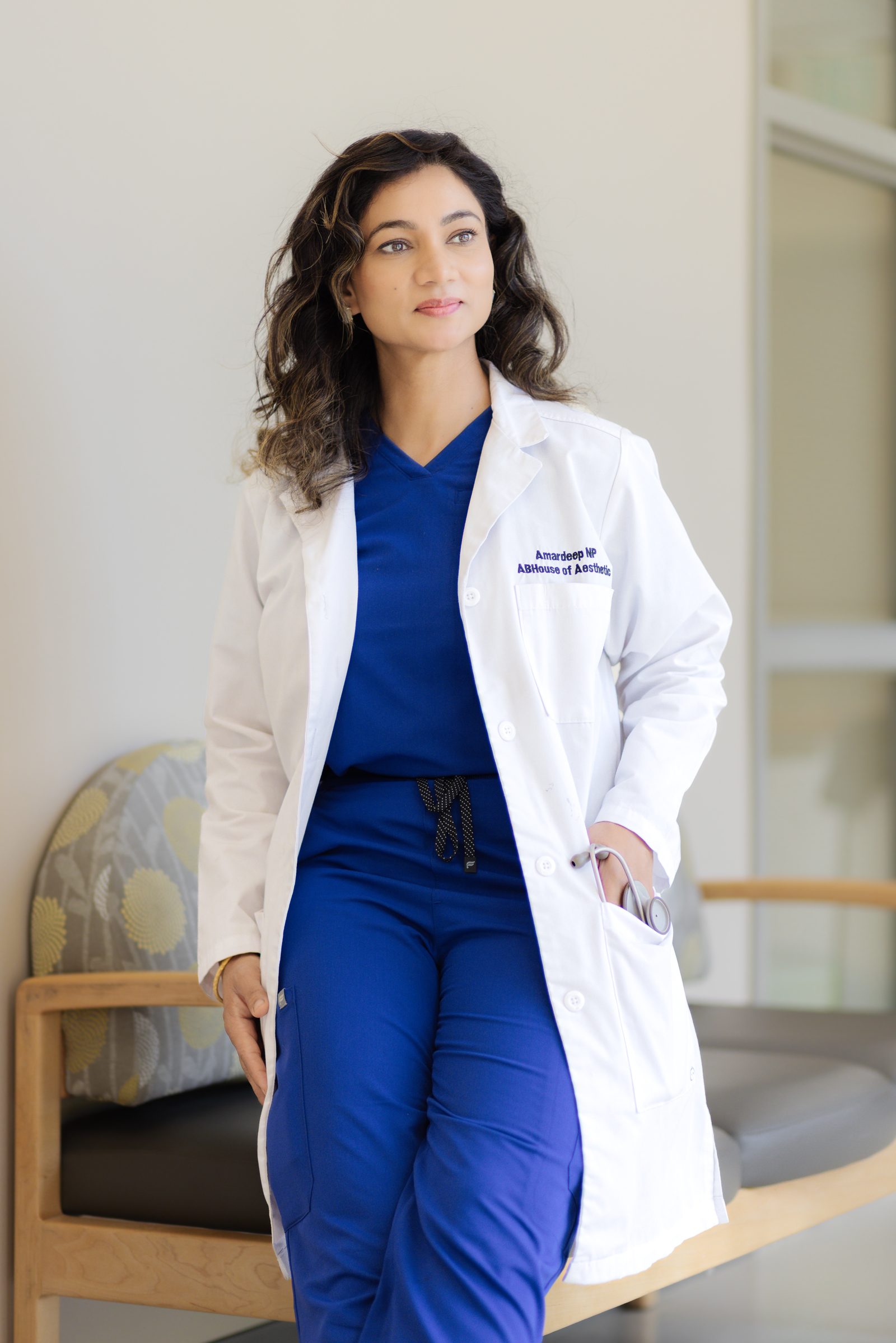 Amardeep Kaur, nurse practitioner and founder of AB House of Aesthetics, wearing her white coat