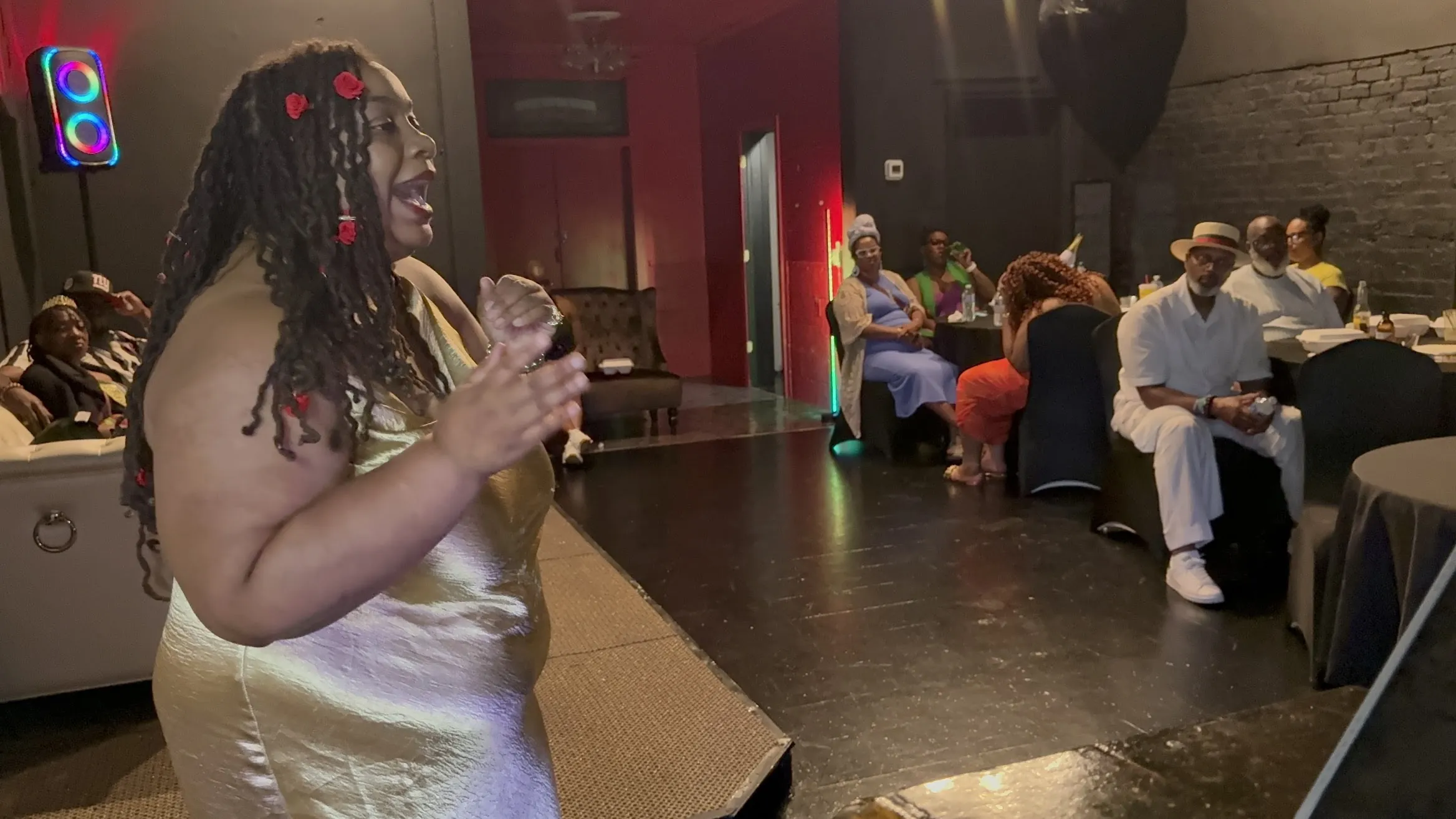 A Badu Lounge guest speaks to the room