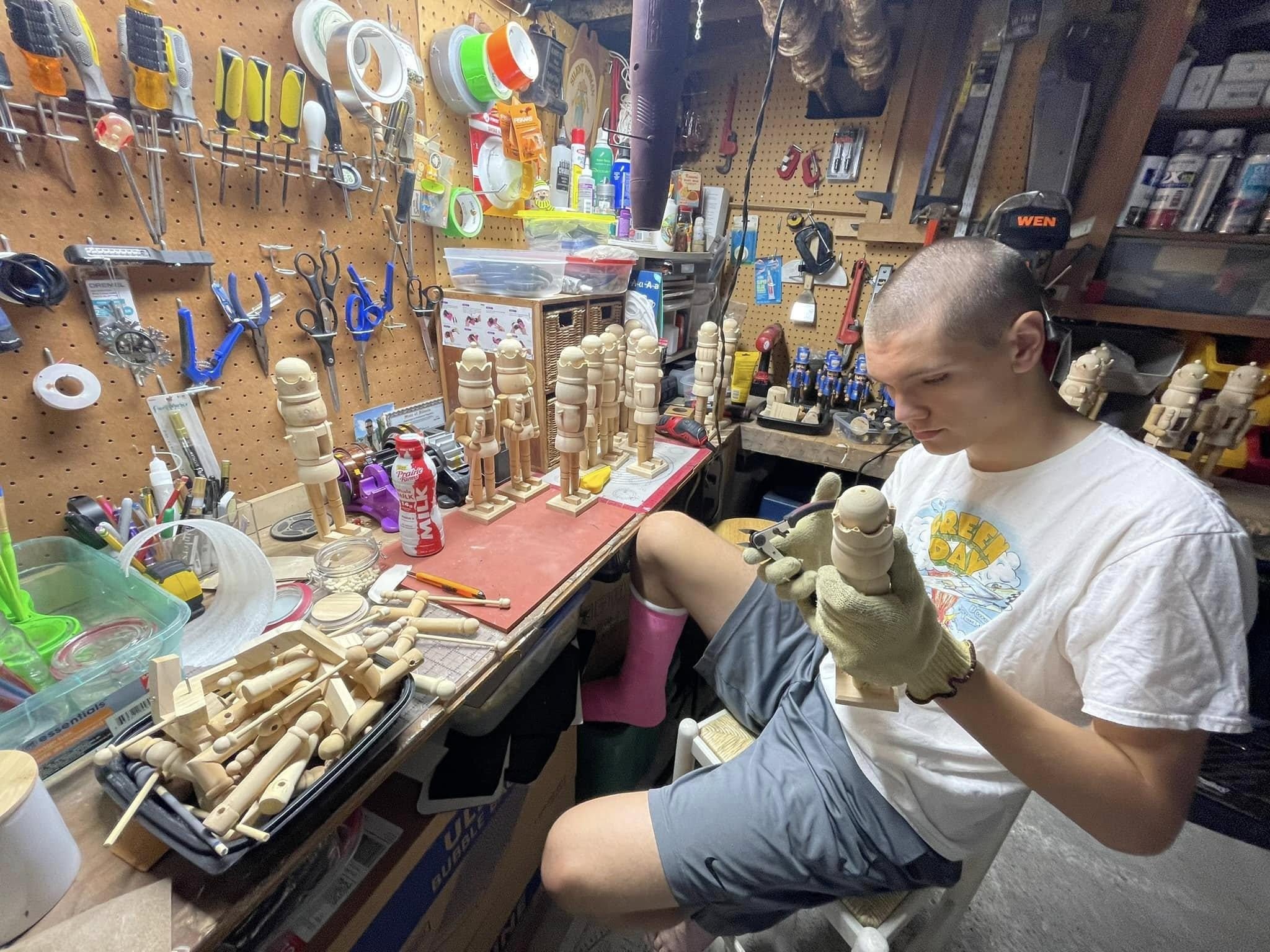 A maker shaping a nutcracker in the workshop