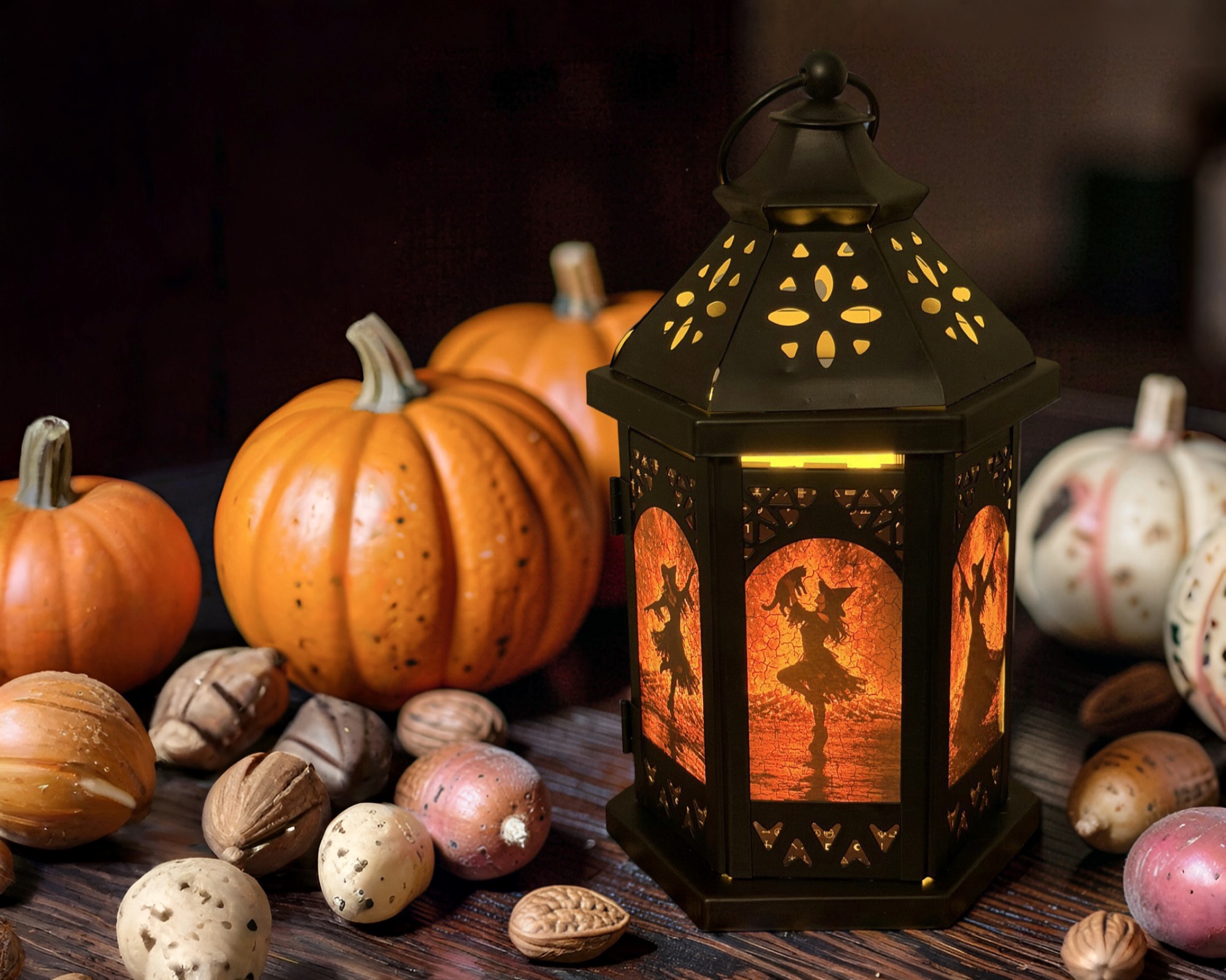 Galena Christmas Company Halloween lantern glowing beside pumpkins and gourds
