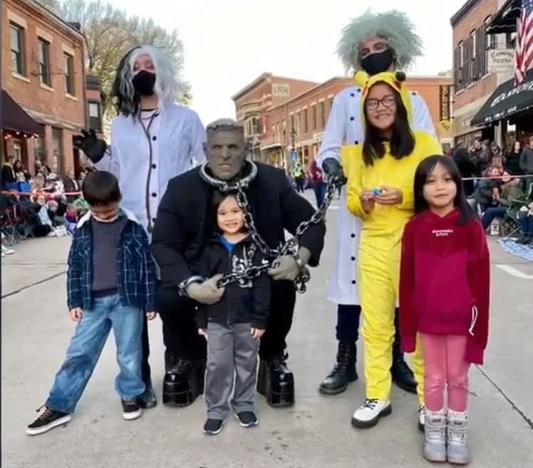 Frankie Stein and family posing with children at the Galena Halloween Parade
