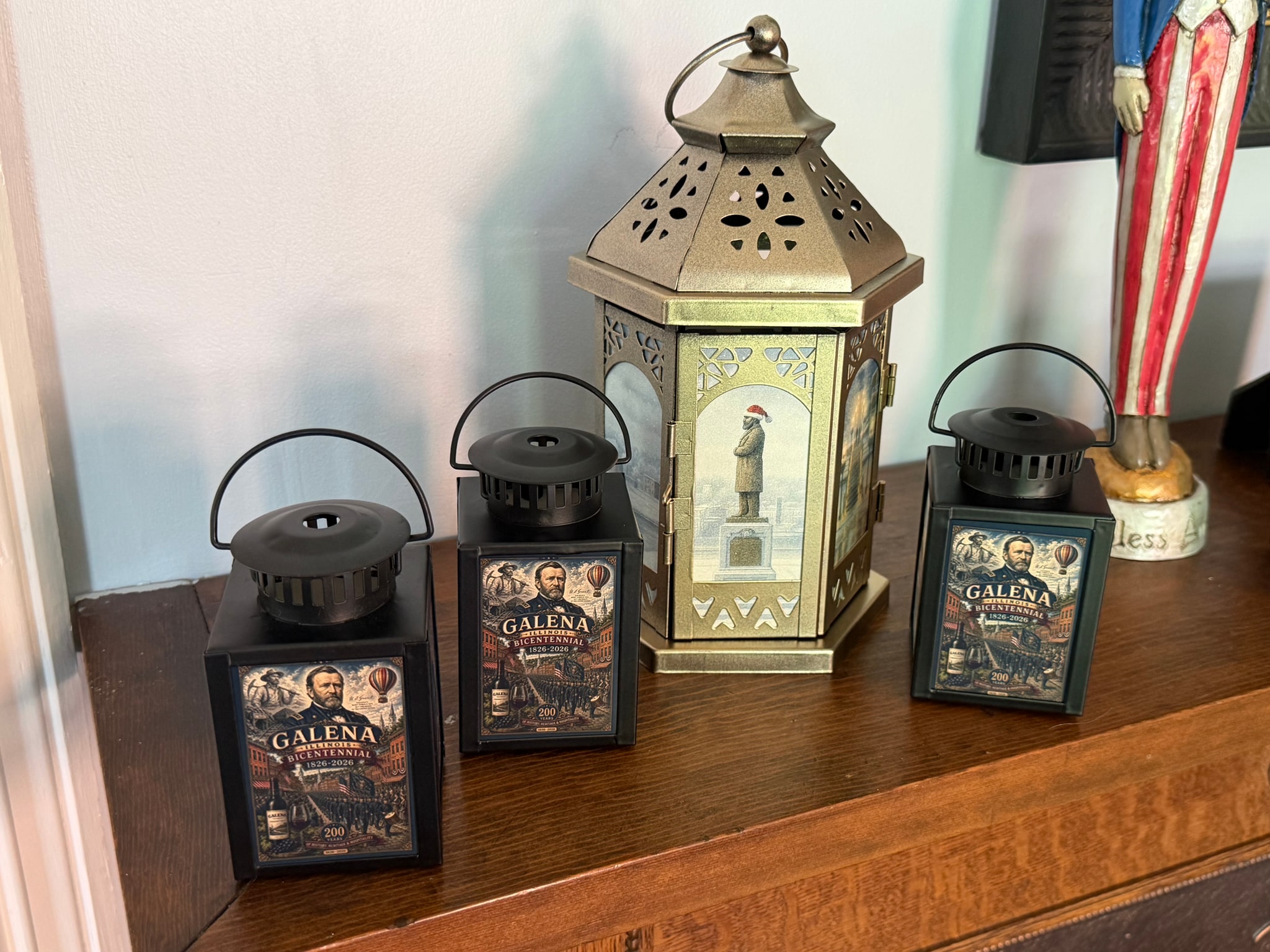 Collection of illuminated lanterns and holiday pieces on a mantel