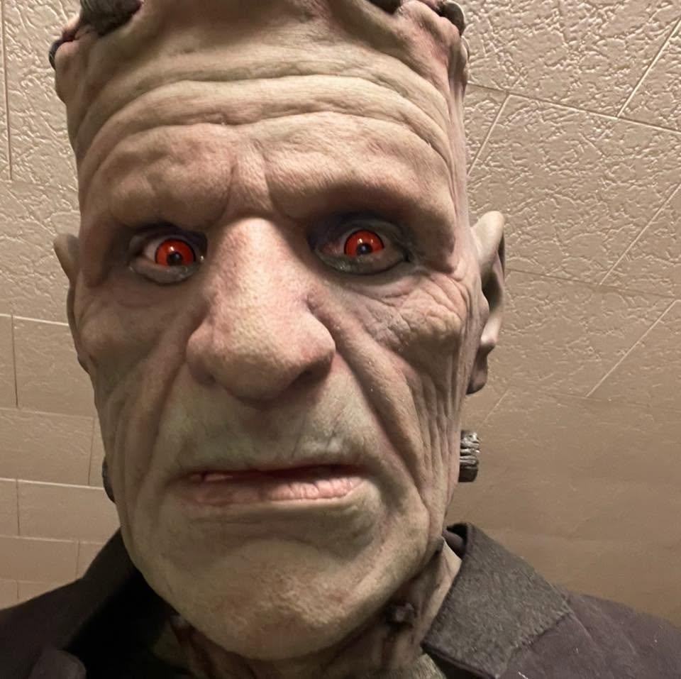 Close-up of Frankie Stein’s Halloween mask and bright red eyes.