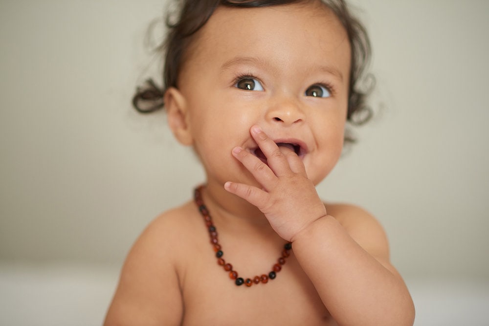 Featured image for Debunking a popular amber myth-Do Amber Baby Necklaces Really Soothe Teething Pain?