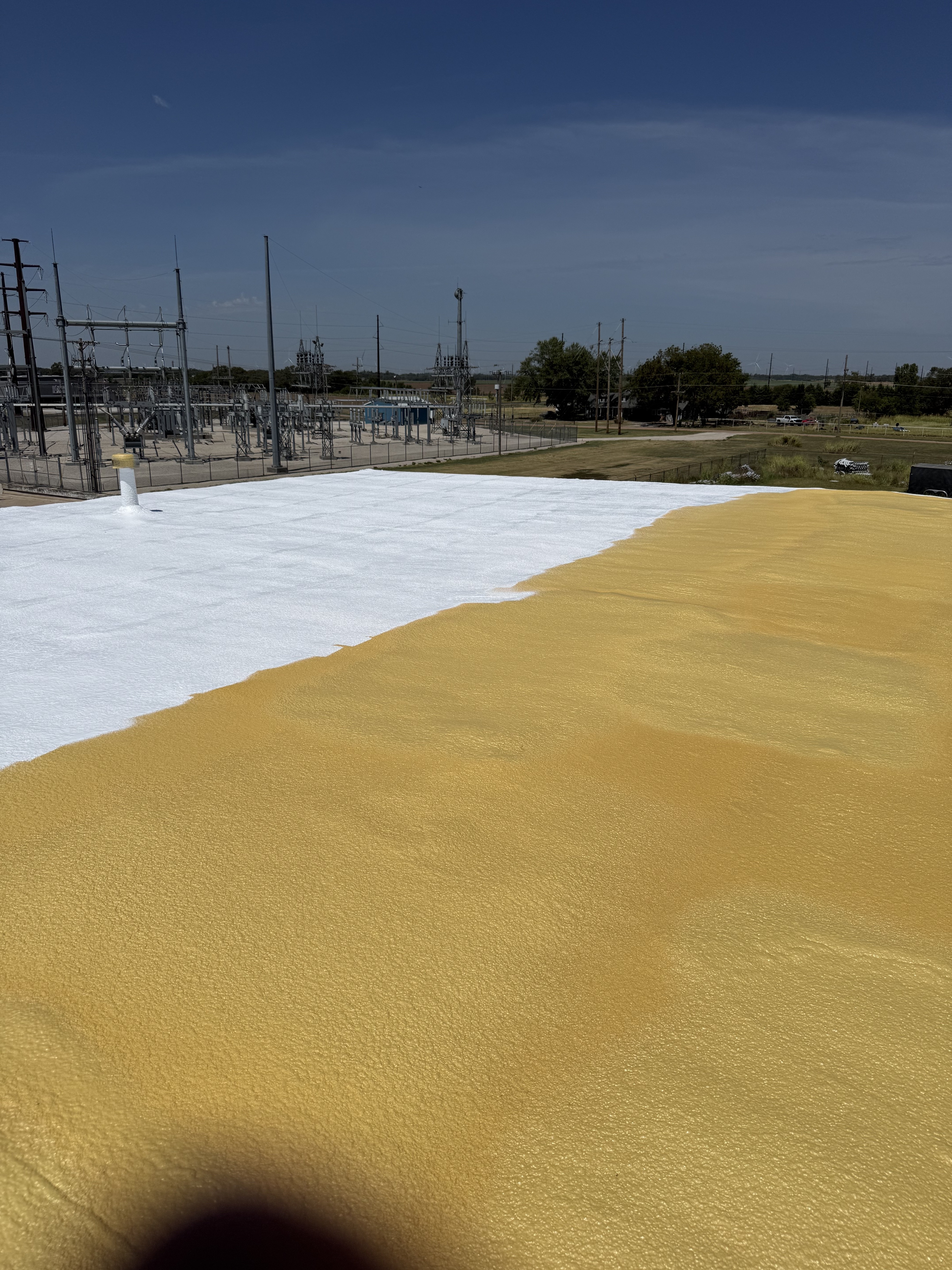Commercial roof coating application in progress