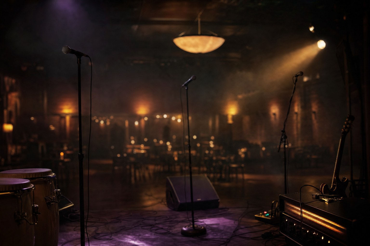 Empty neighbourhood stage with microphones, congas, guitar amplifier, and warm lights