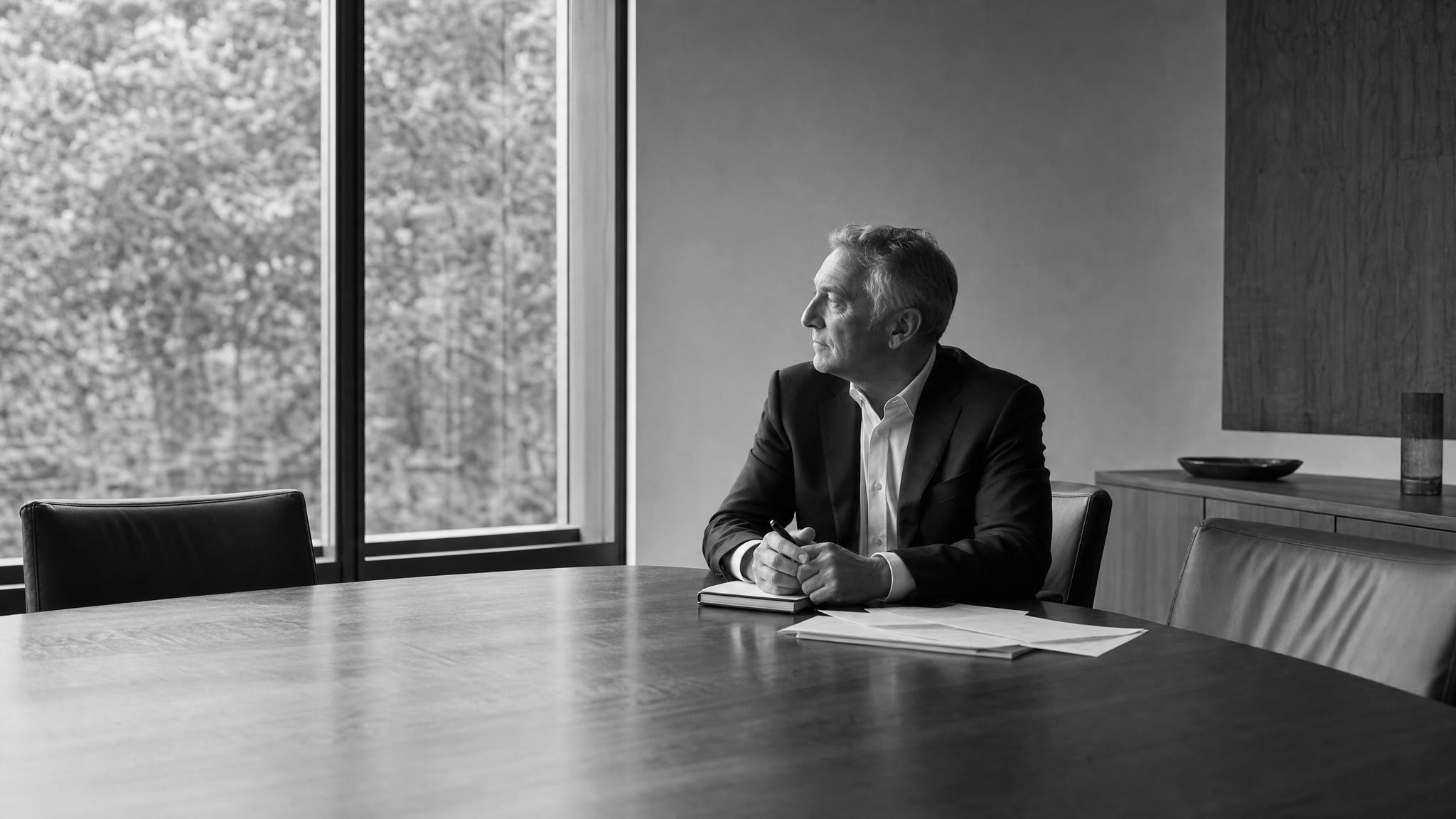 Business leader considering decision notes in a quiet meeting room