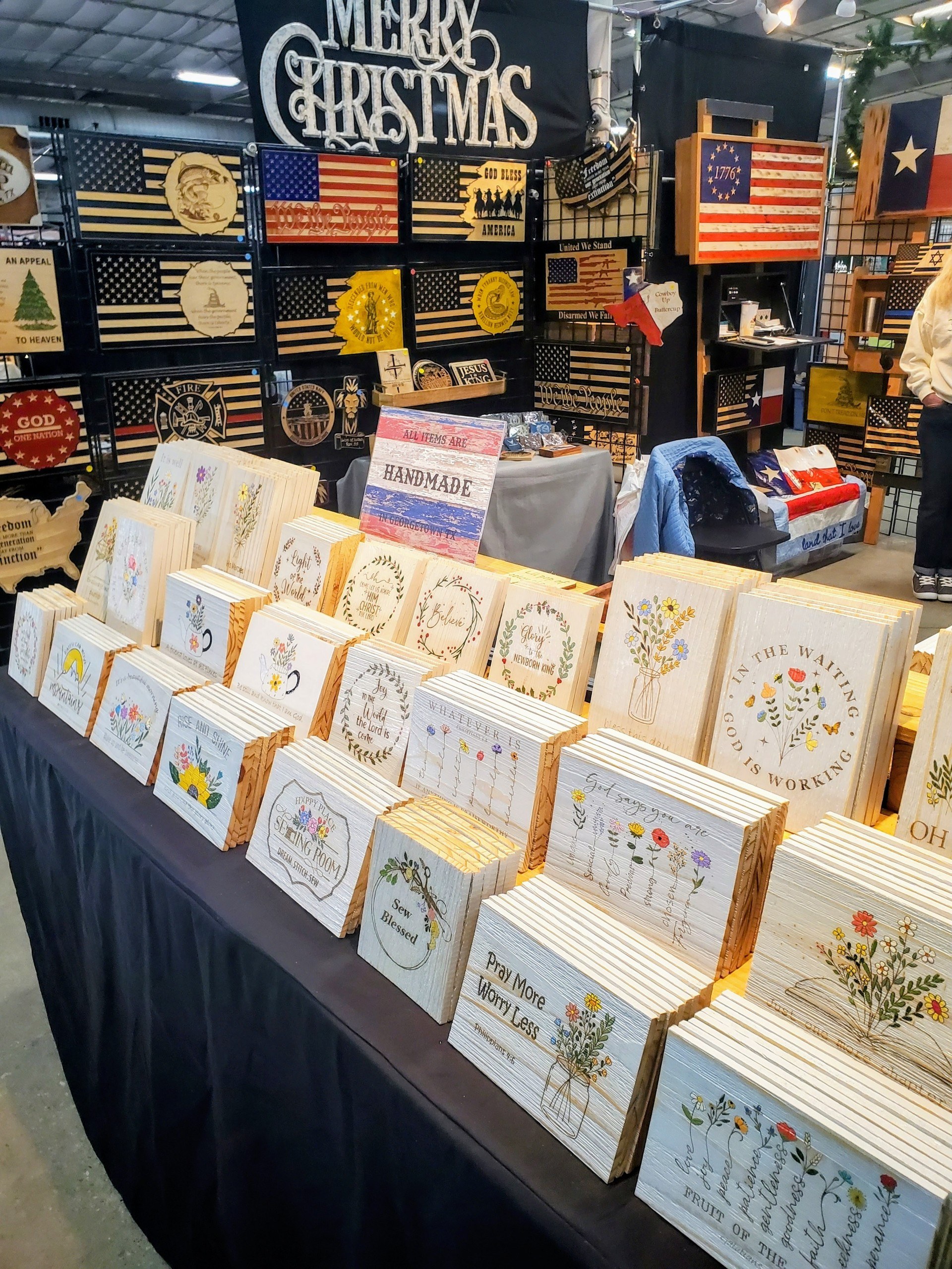 Brothers Grimm Woodworks market booth filled with handmade flags and wooden gifts