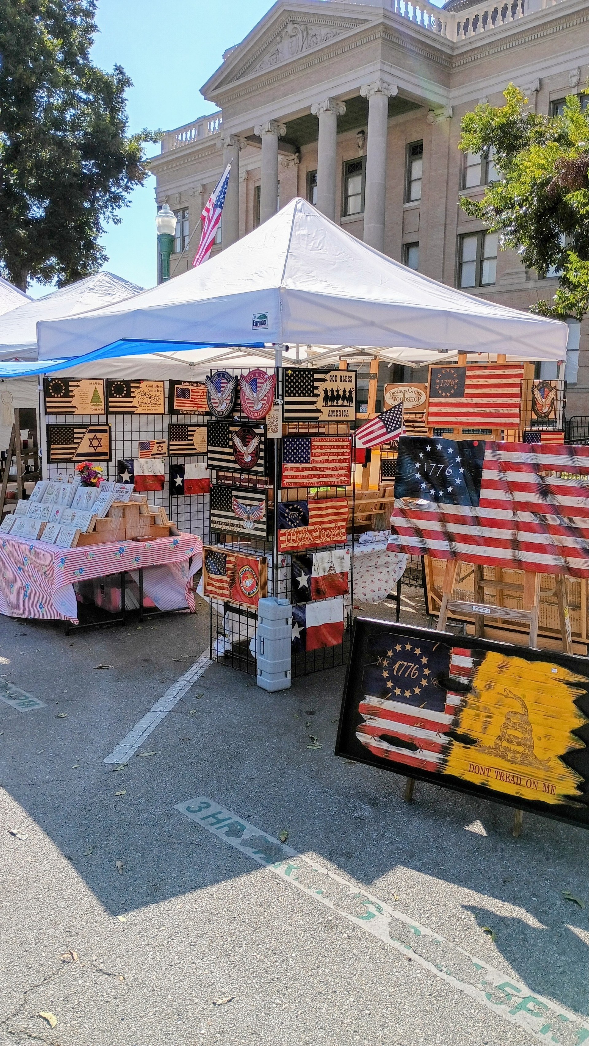 Brothers Grimm Woodworks outdoor market booth with handmade American flags