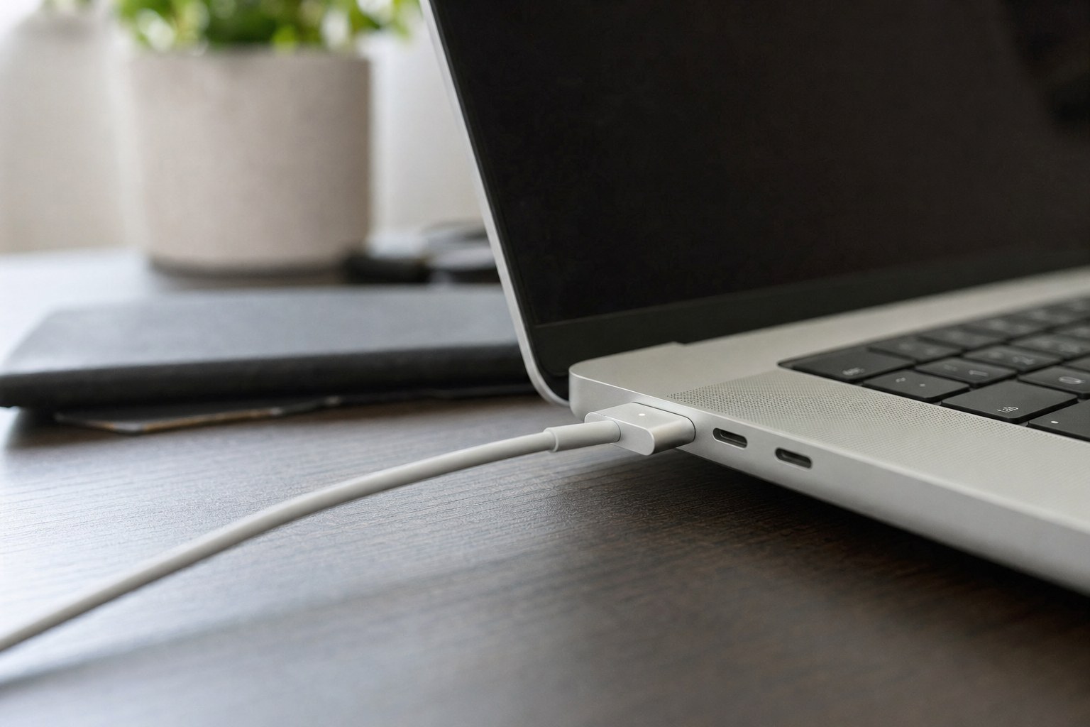 USB-C power cable seated in a laptop charging port