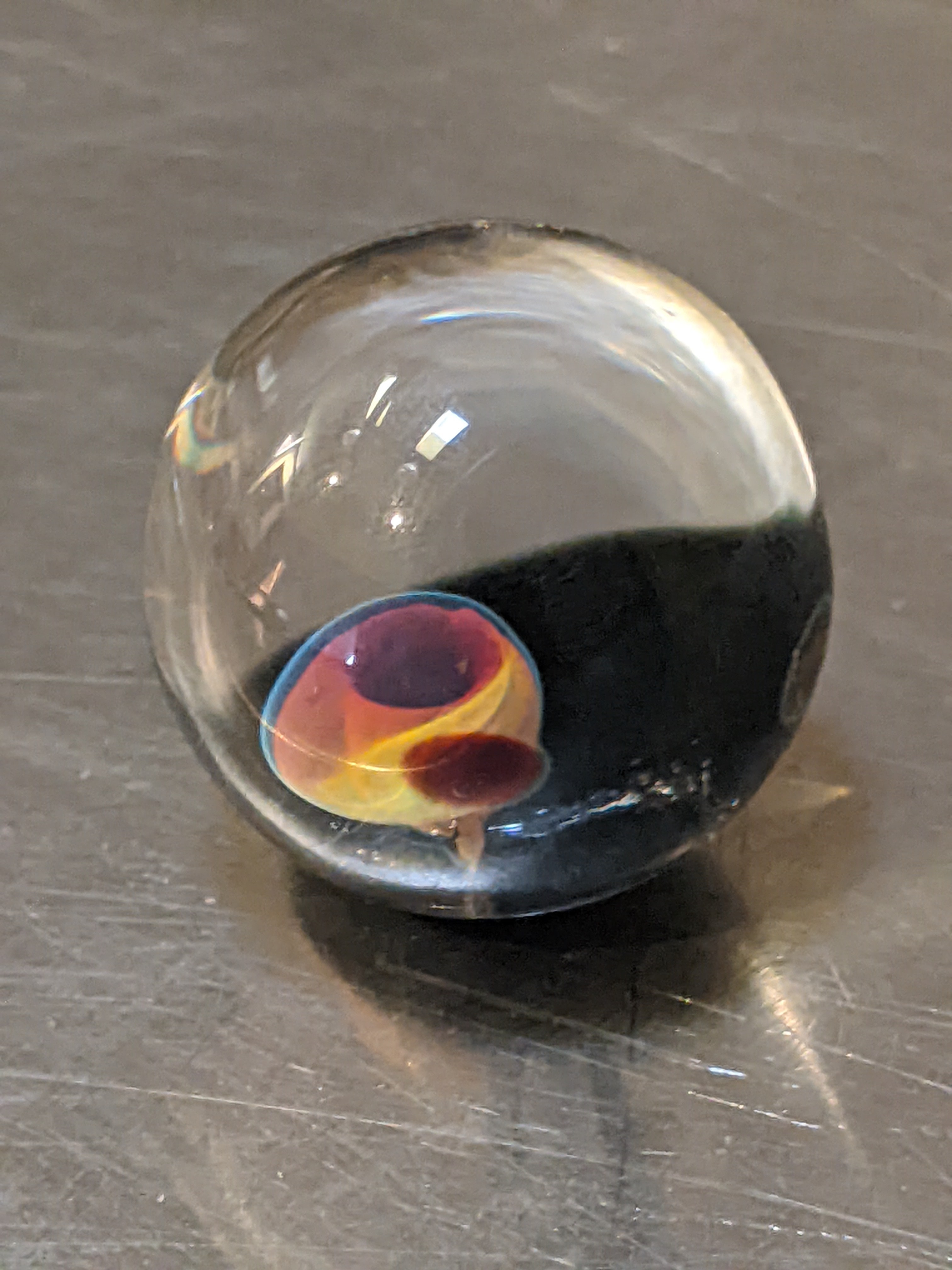 Clear glass orb with colored details inside