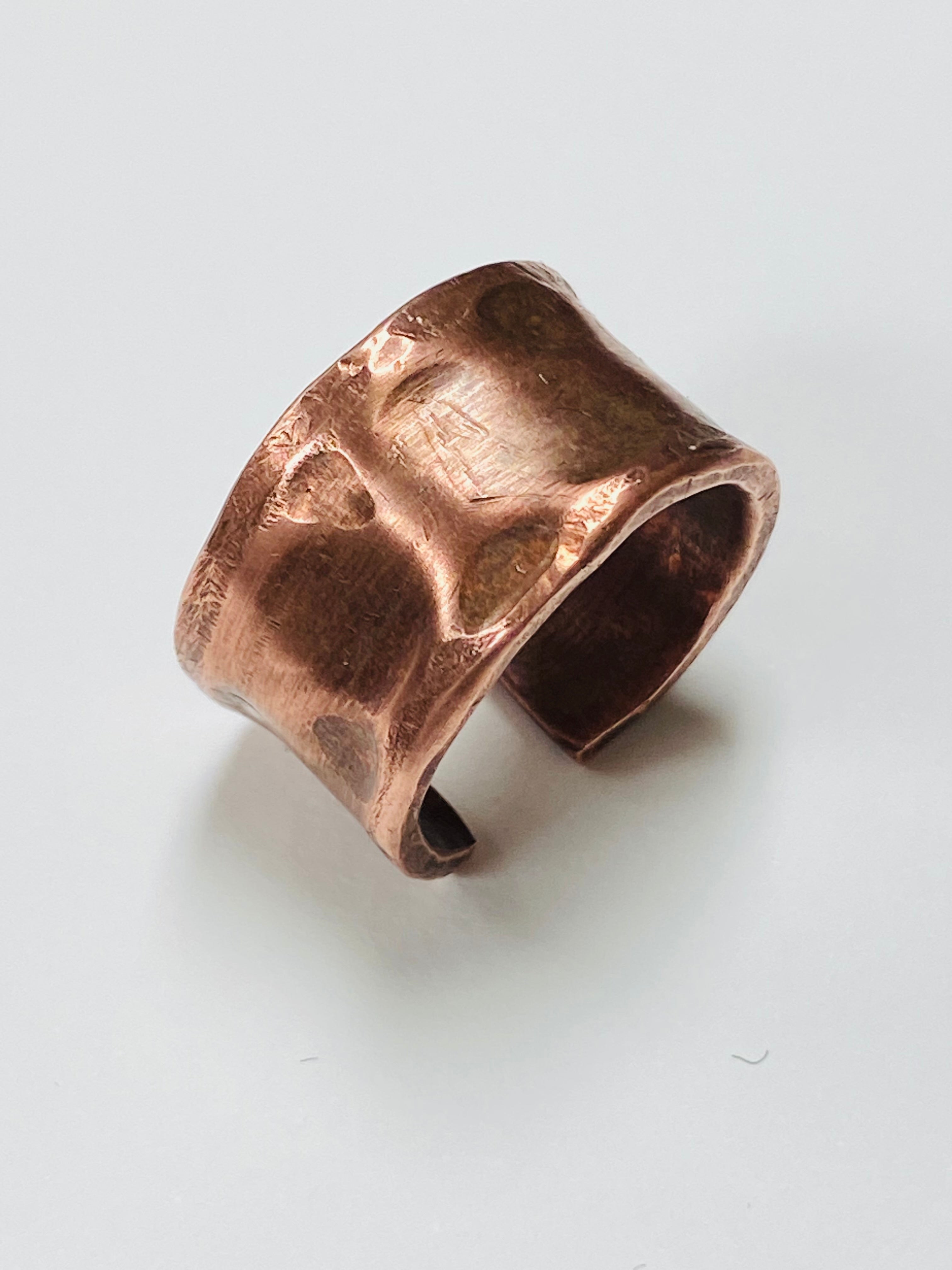 Handmade raw copper ring with a textured surface