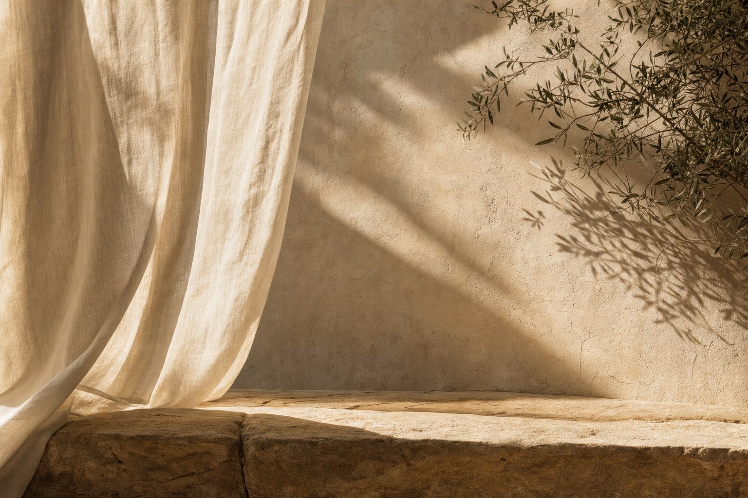 Soft sunlight falling through cream linen onto sandstone