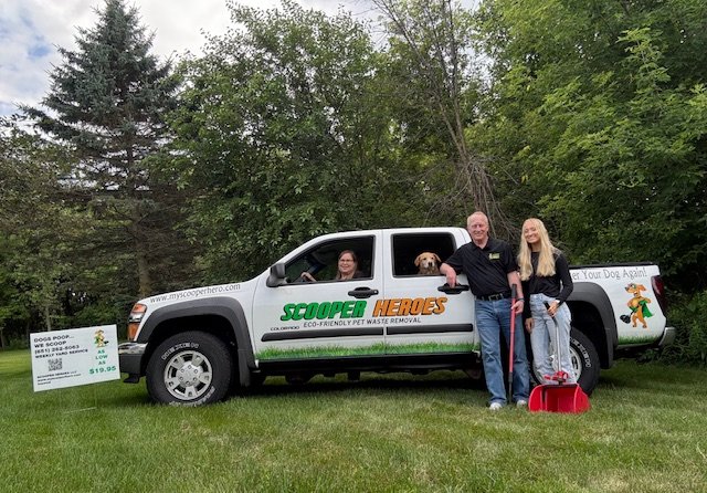 My Scooper Hero family beside their branded truck