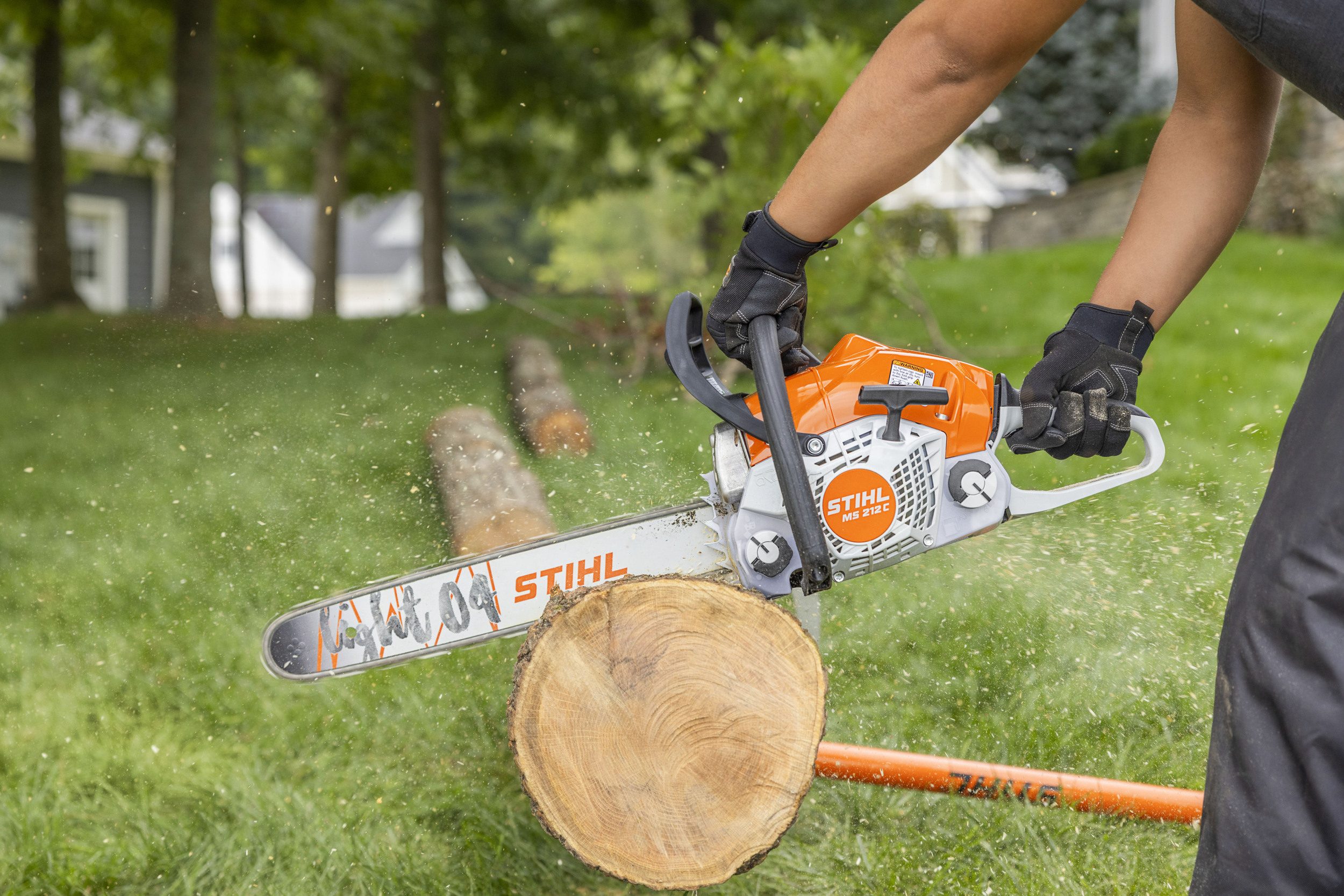 STIHL chainsaw cutting a log with lubricated bar and chain