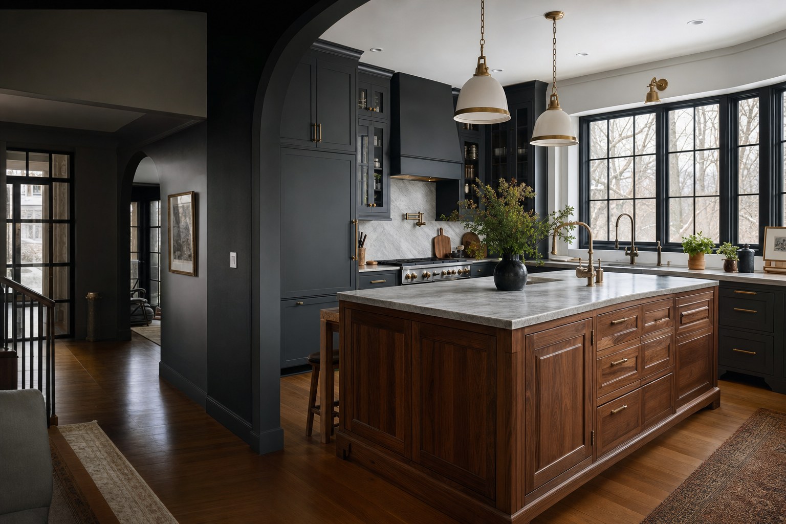 Dark kitchen with a walnut island and tall black-framed windows