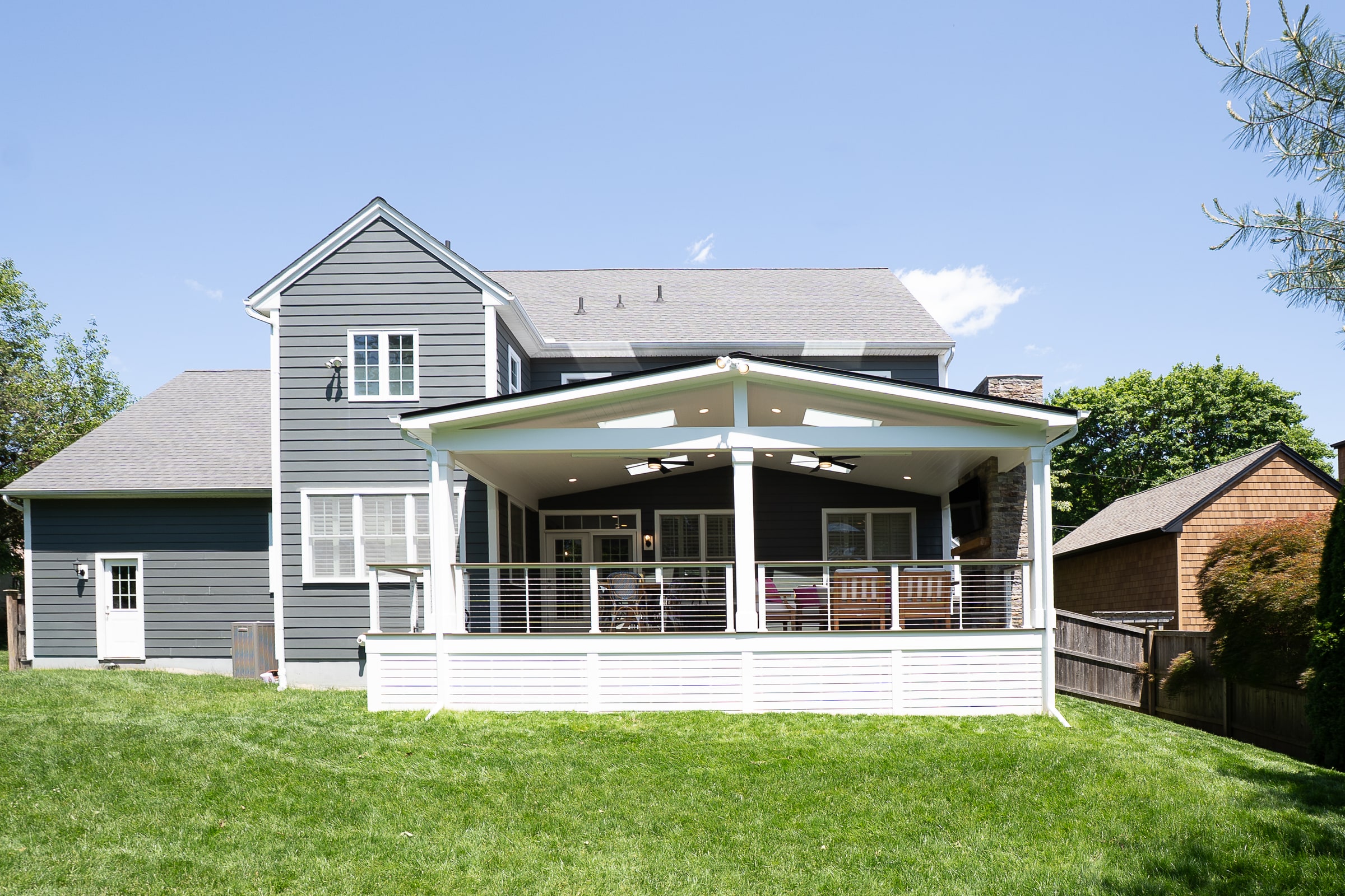 Completed covered porch and rear exterior by EMC Contracting