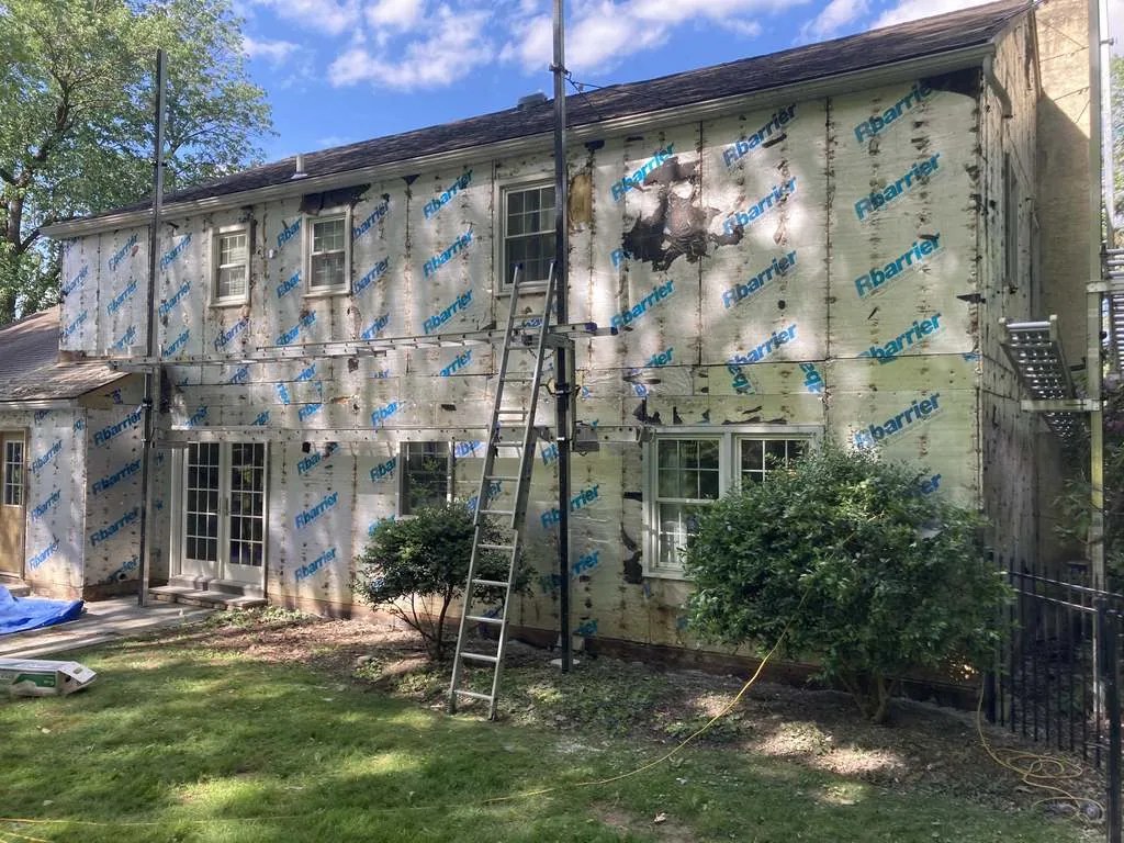 House wrap installation in progress