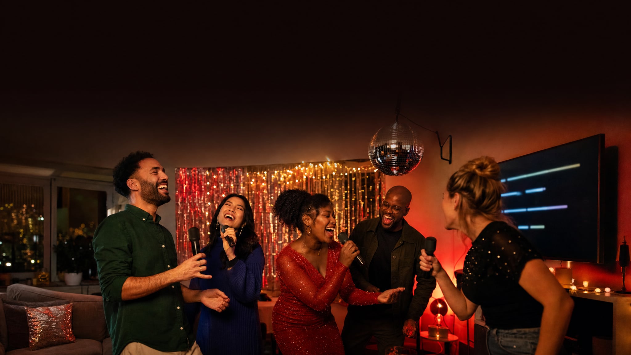 Friends singing together in a decorated home karaoke room