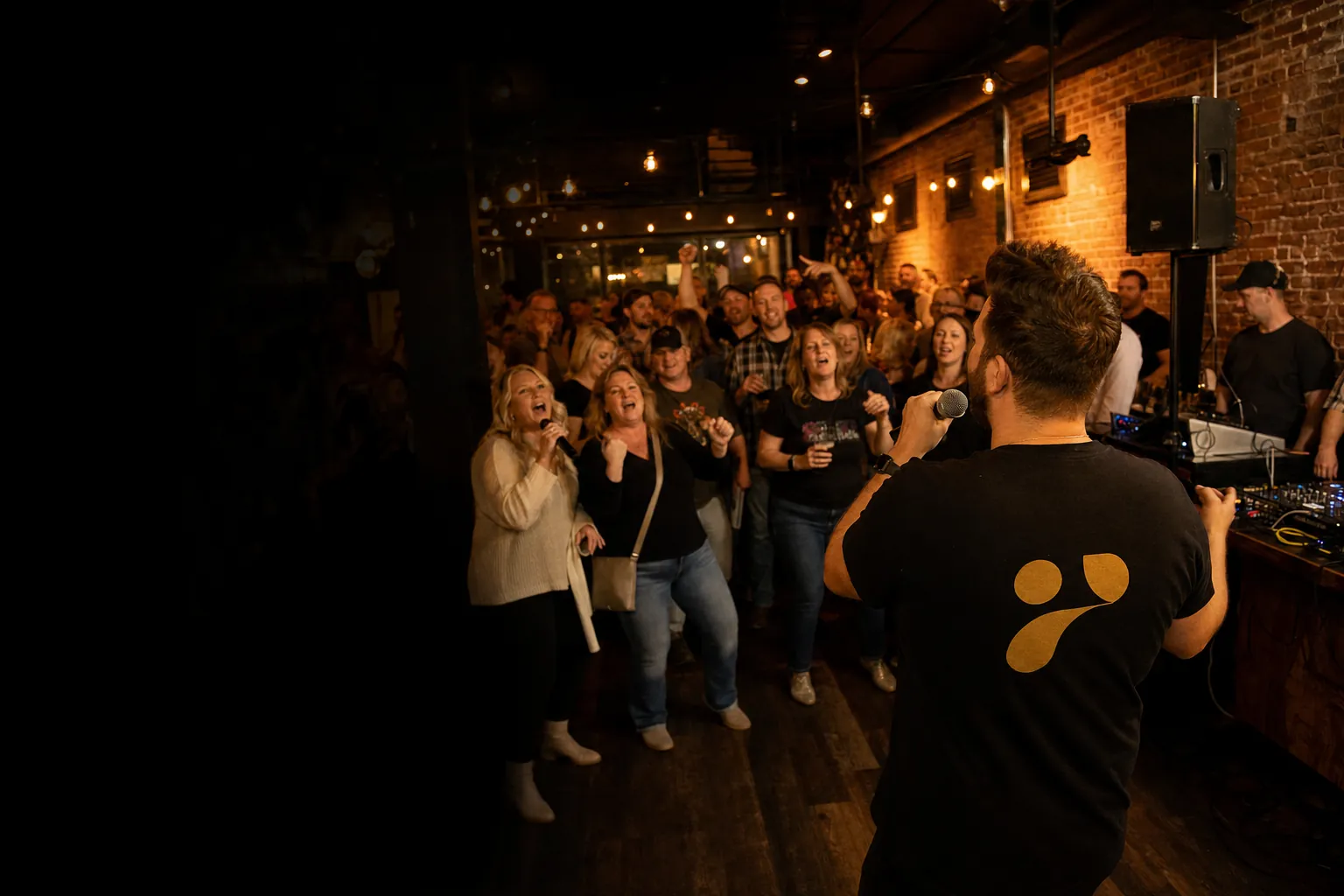 Karaoke host leading a lively crowd at a warmly lit event