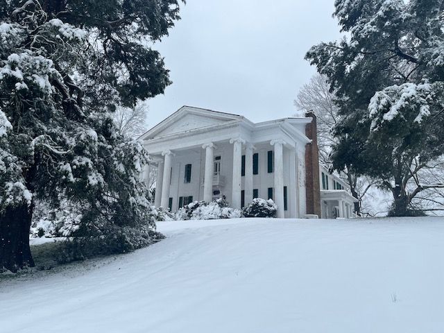 The historic house surrounded by snow