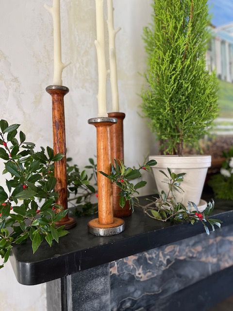 Candles and seasonal greenery on the mantel