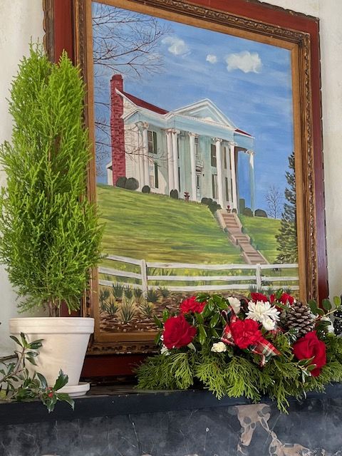 A painting of the house with seasonal decorations