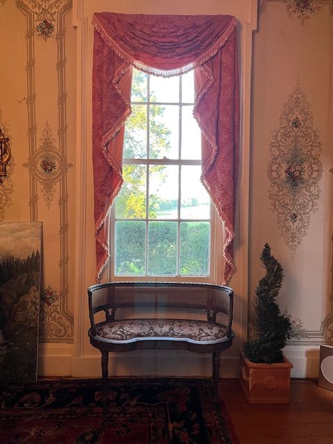 A window framed by patterned curtains