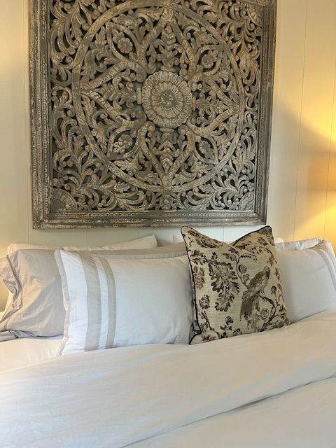 Decorative headboard and pillows in a guest bedroom