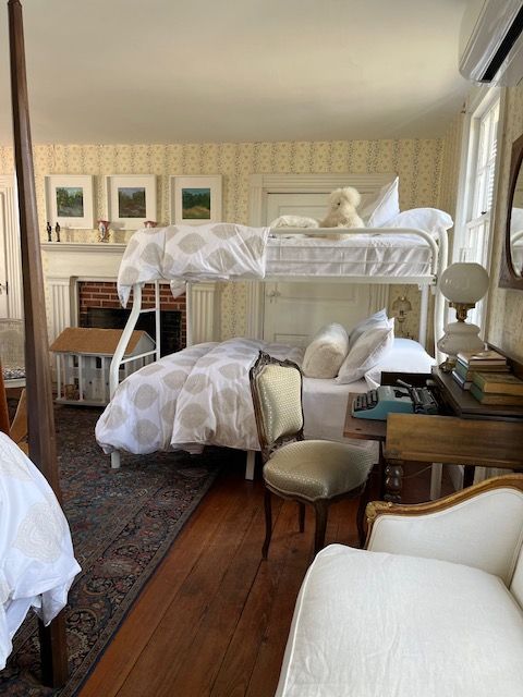 Twin beds and antique furnishings in a guest bedroom