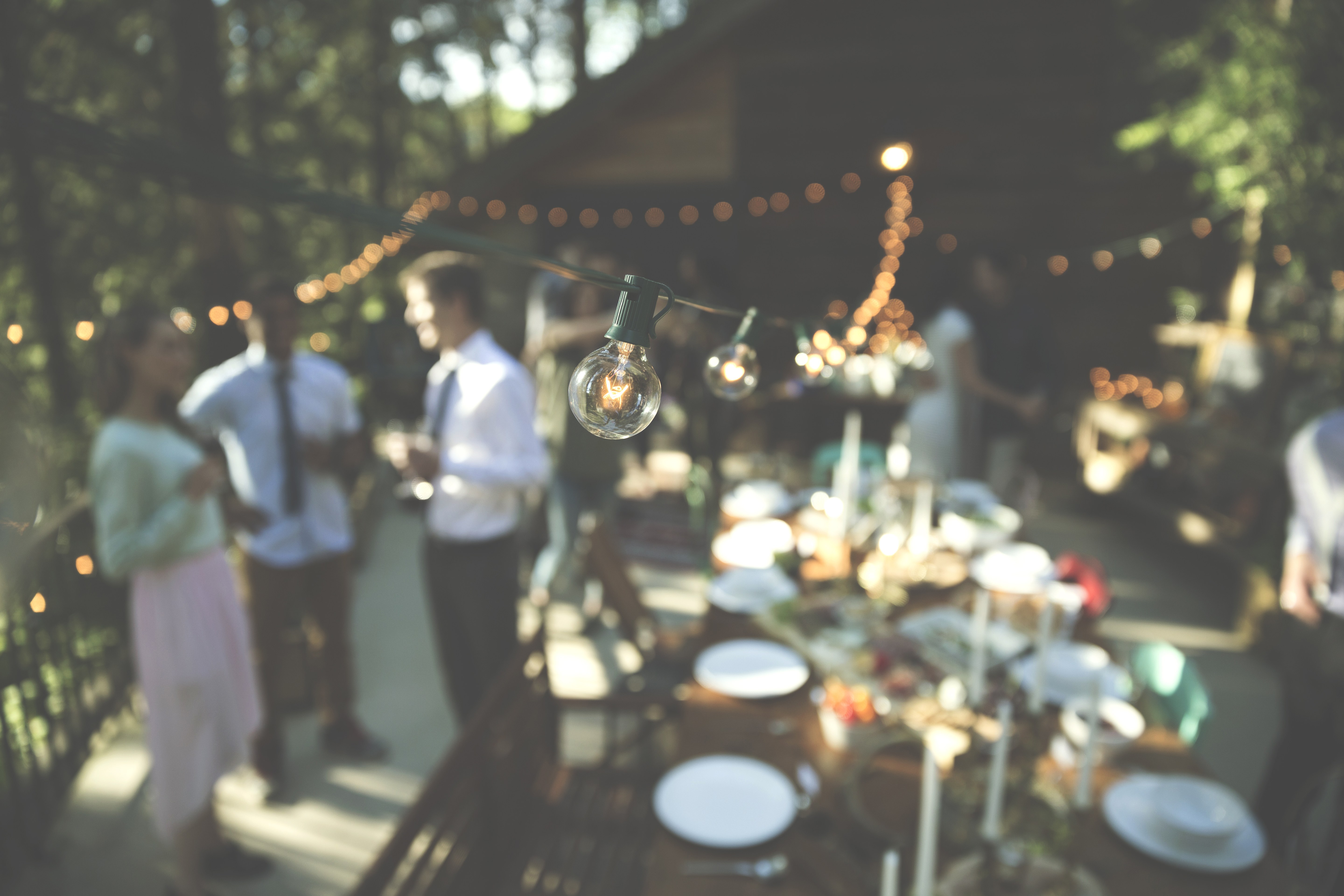 An outdoor gathering around a decorated table