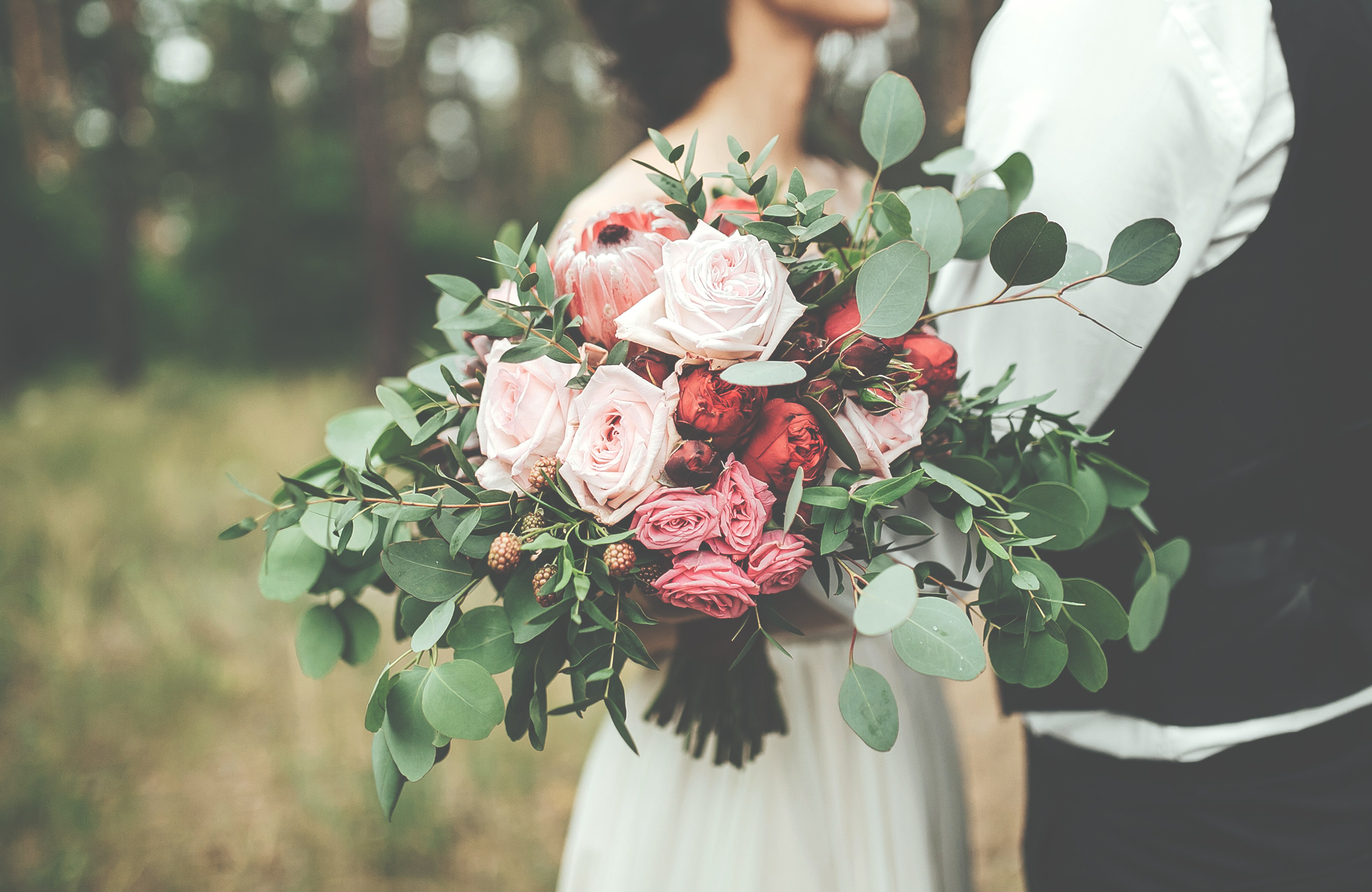 A wedding bouquet of pink and cream roses