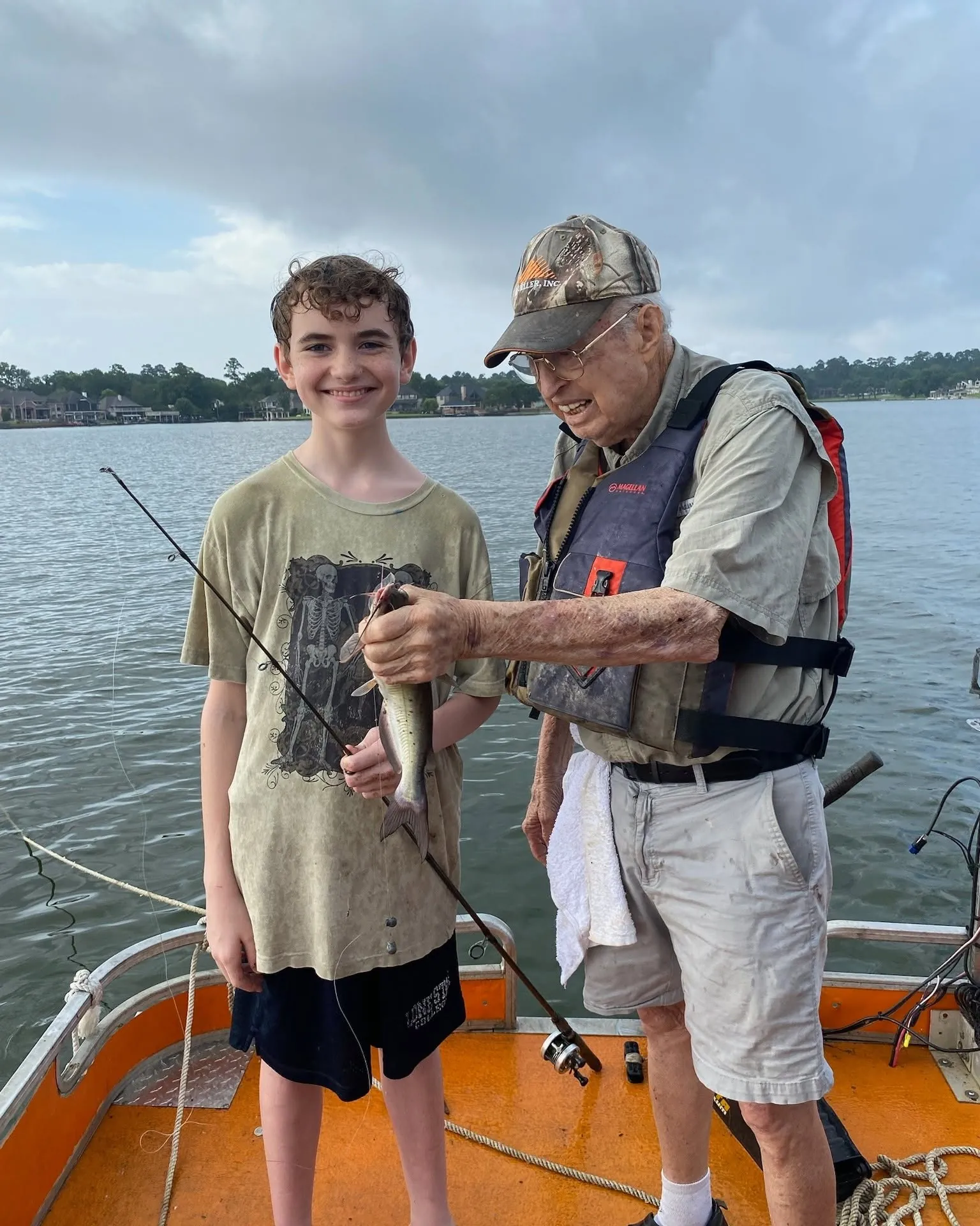 Billy helping a young angler hold a fish on Lake Conroe. Lake Conroe Fishing Guide - Billy Mills