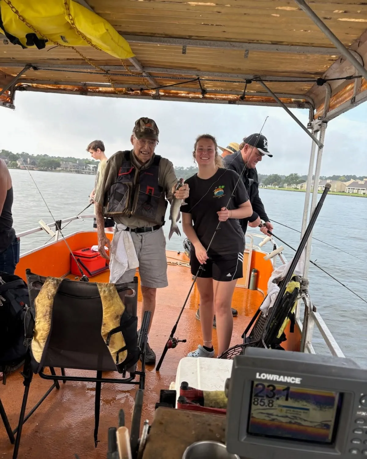 Guests gathered on a covered Lake Conroe fishing boat. Lake Conroe Fishing Guide - Billy Mills